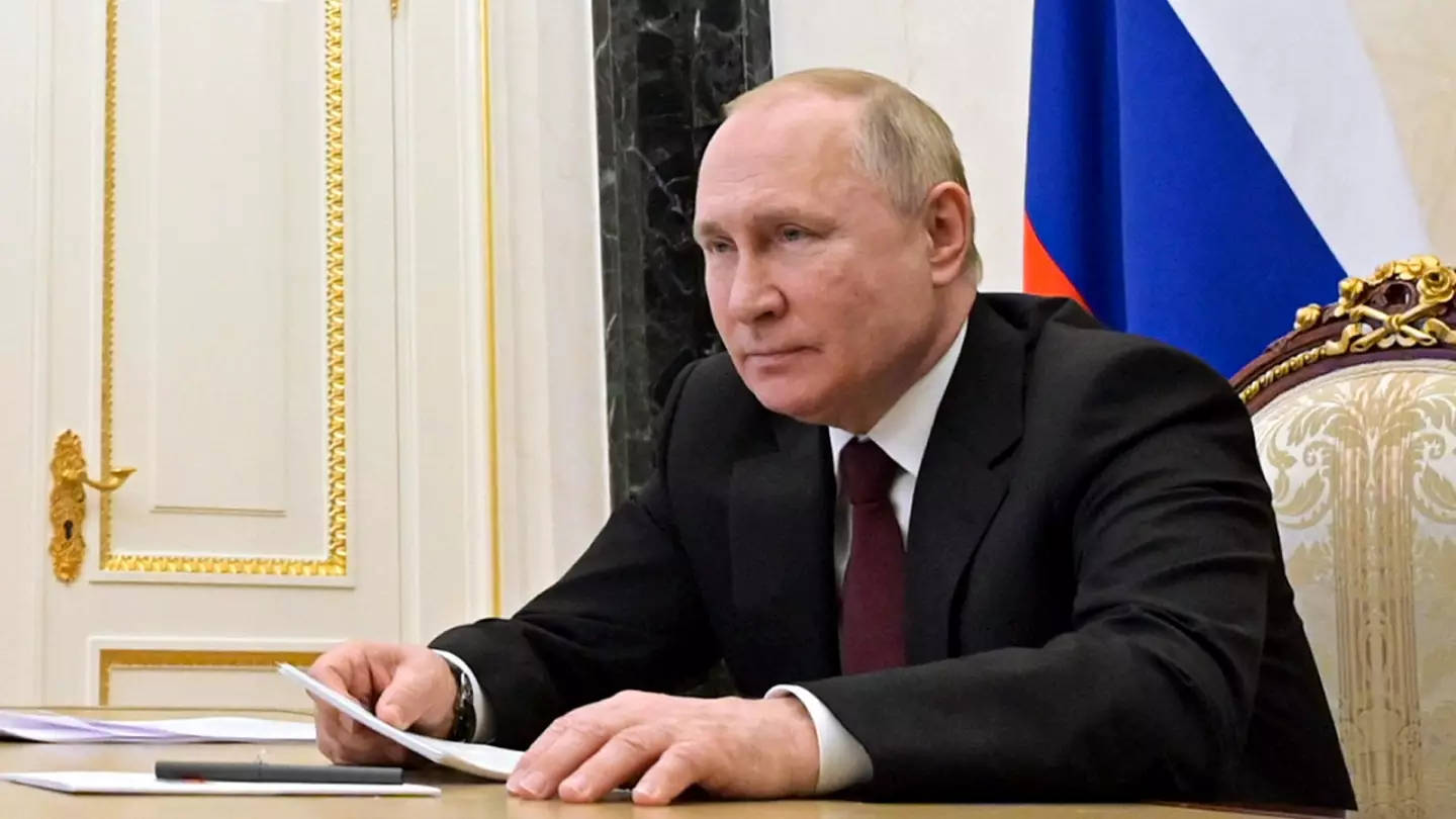 Vladimir Putin Holding Papers While Seating Background