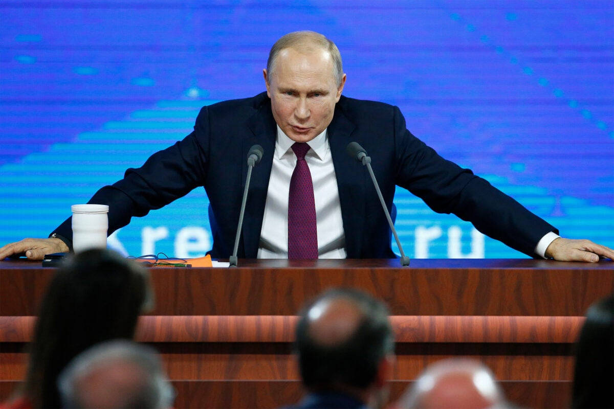 Vladimir Putin With Both Hands On Podium