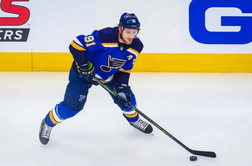 Vladimir Tarasenko Dribbling Hockey Puck On Ice Rink Background