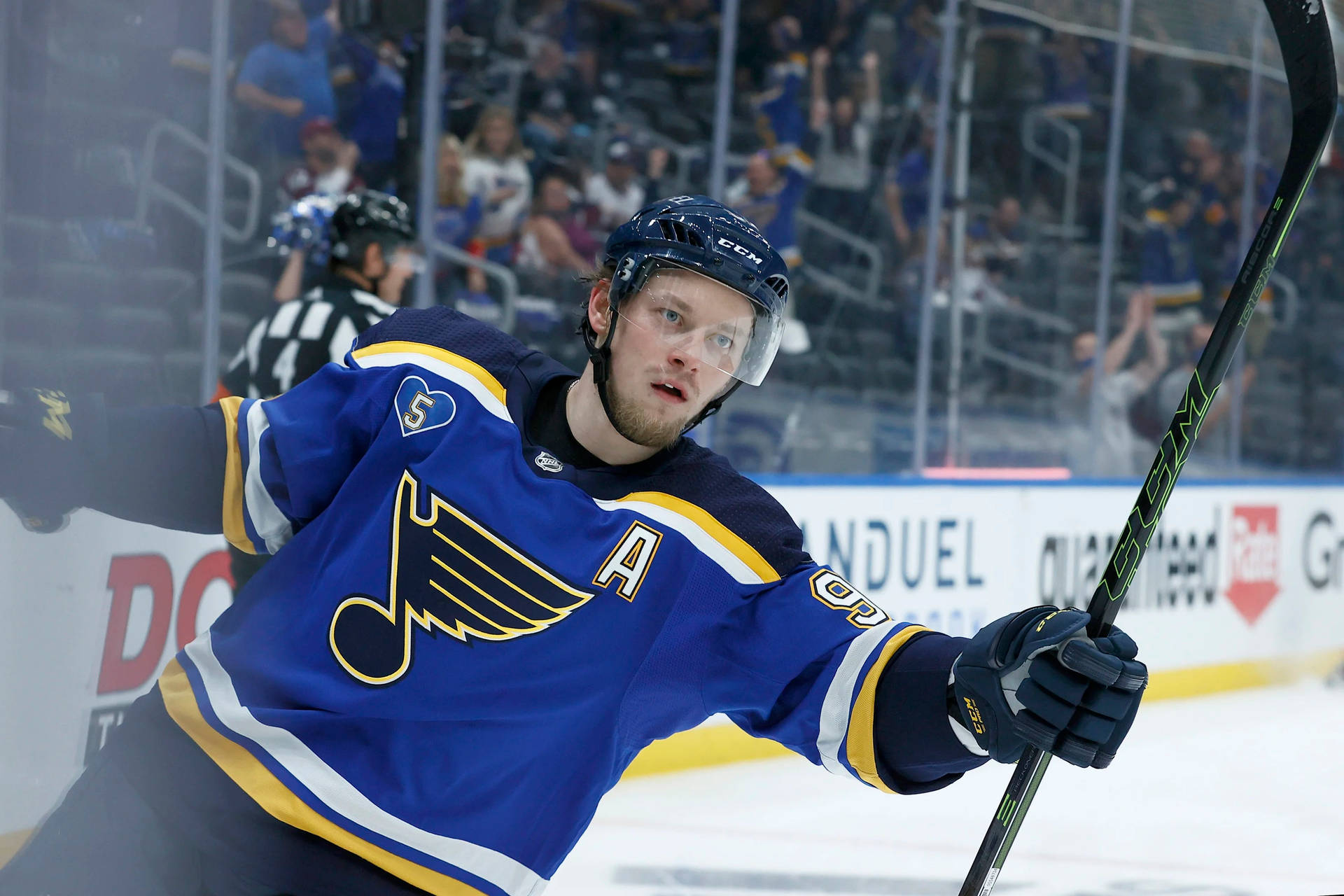 Vladimir Tarasenko Holding Hockey Stick With Left Hand And Holding Side Rink Rails Background