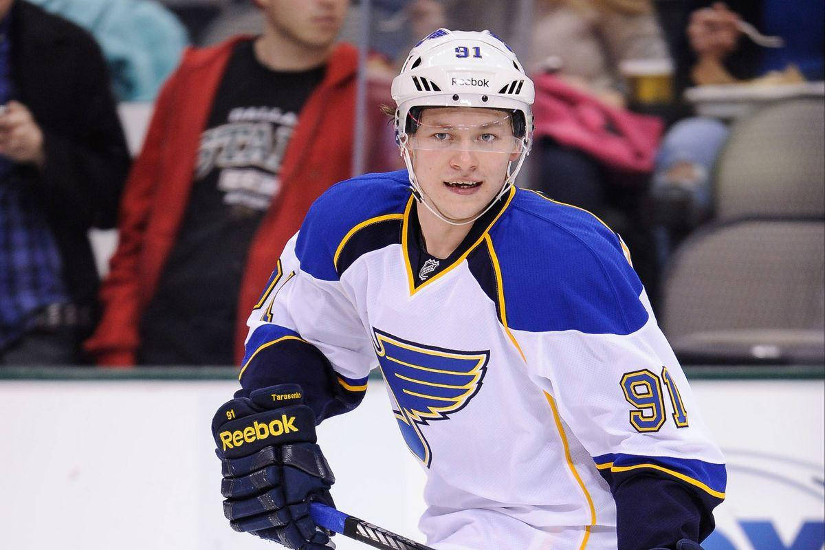 Vladimir Tarasenko Wearing White Jersey And Holding Hockey Stick Background