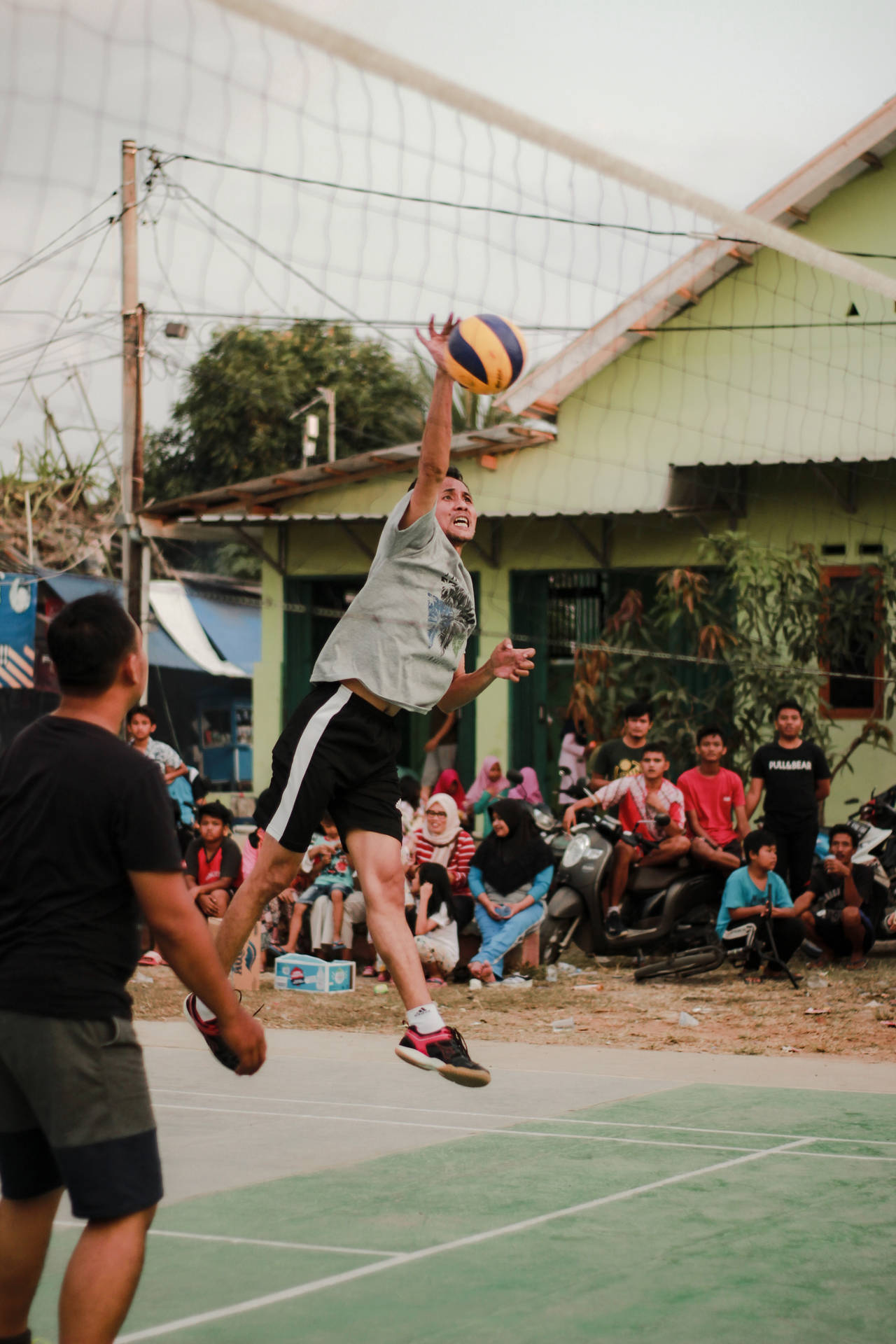 Volleyball Match At A Village Background
