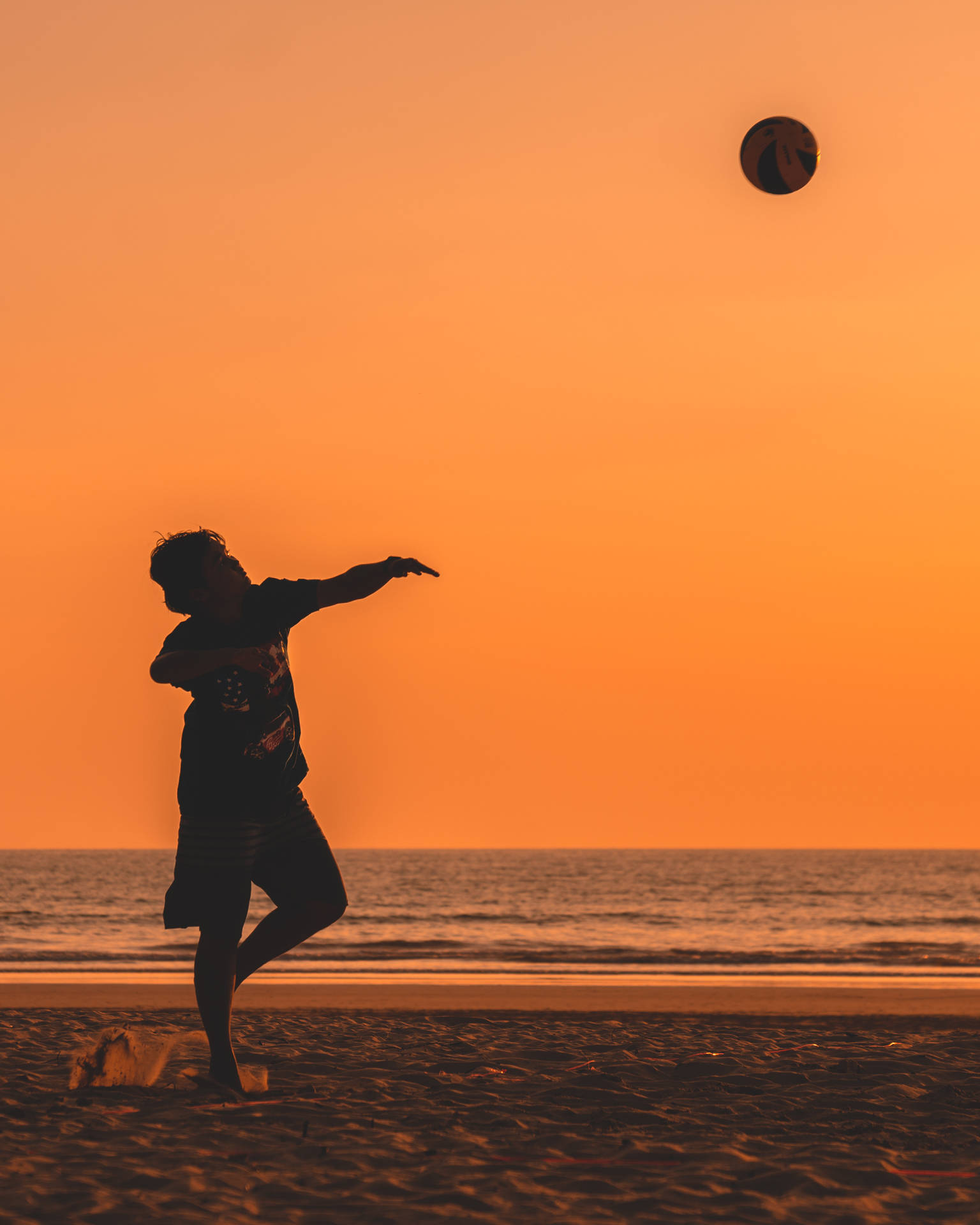 Volleyball Silhouette In Tangerine Beach Background