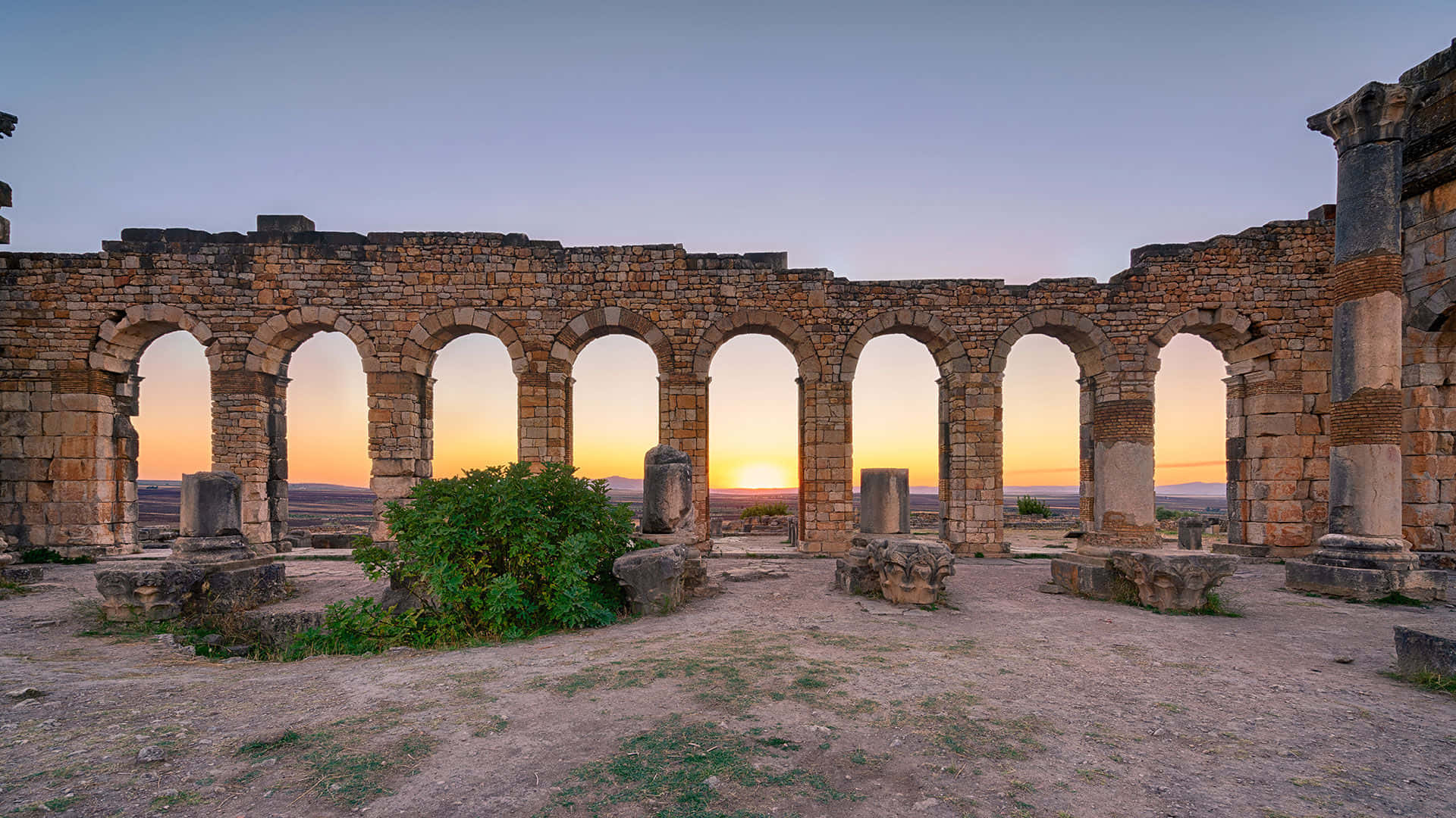 Volubilis Sunset Behind Arches Background