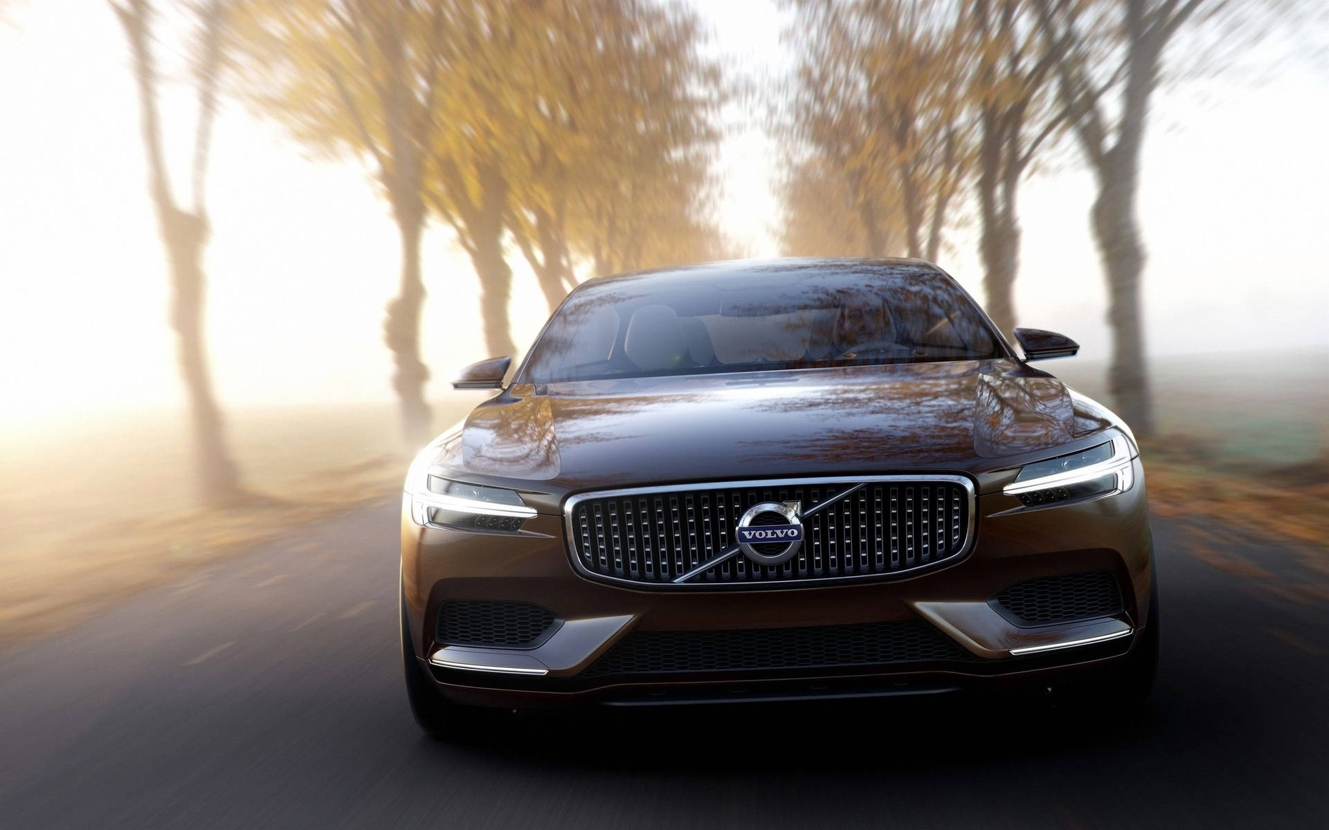 Volvo Xc90 Concept Driving Down A Road Background