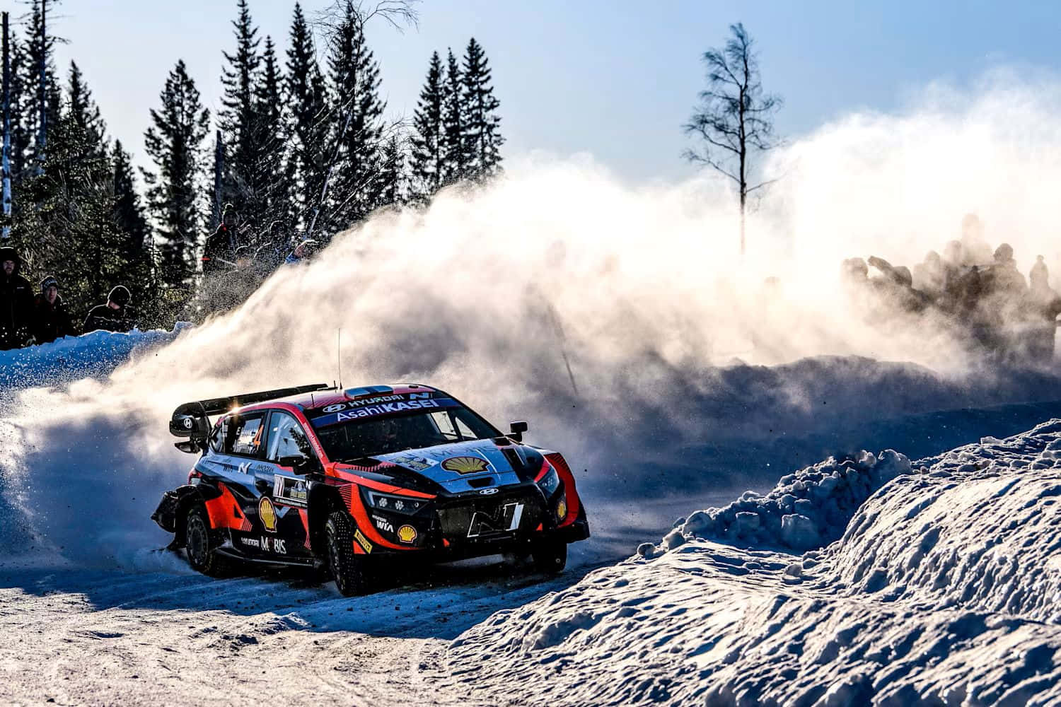 W R C Rally Car Speeding Through Snow Background