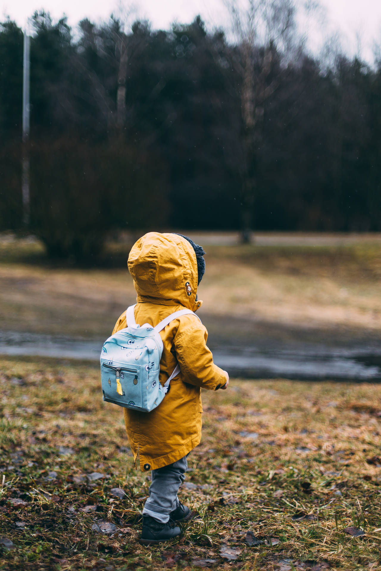 Walking Child In Yellow Raincoat Background