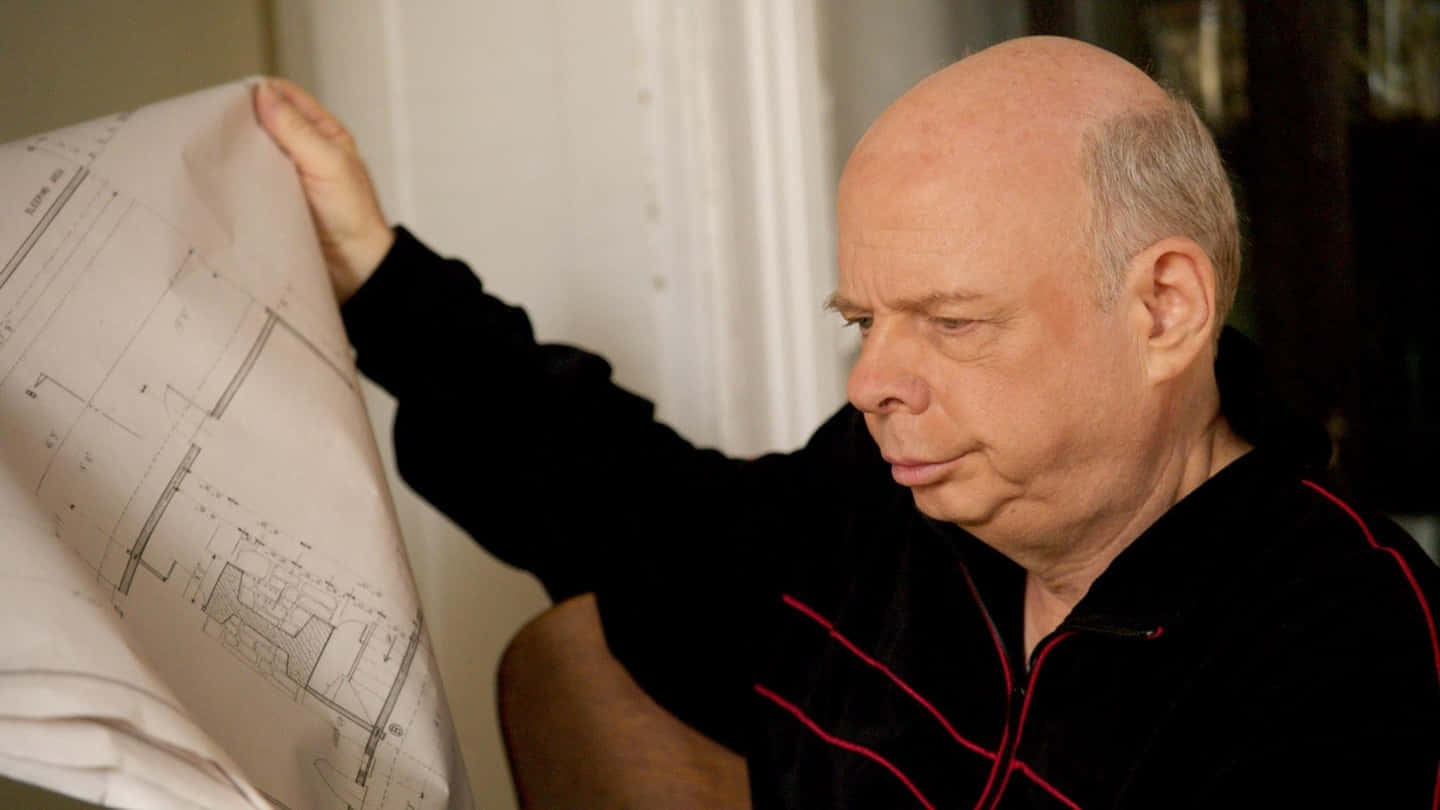 Wallace Shawn Posing During A Media Event Background