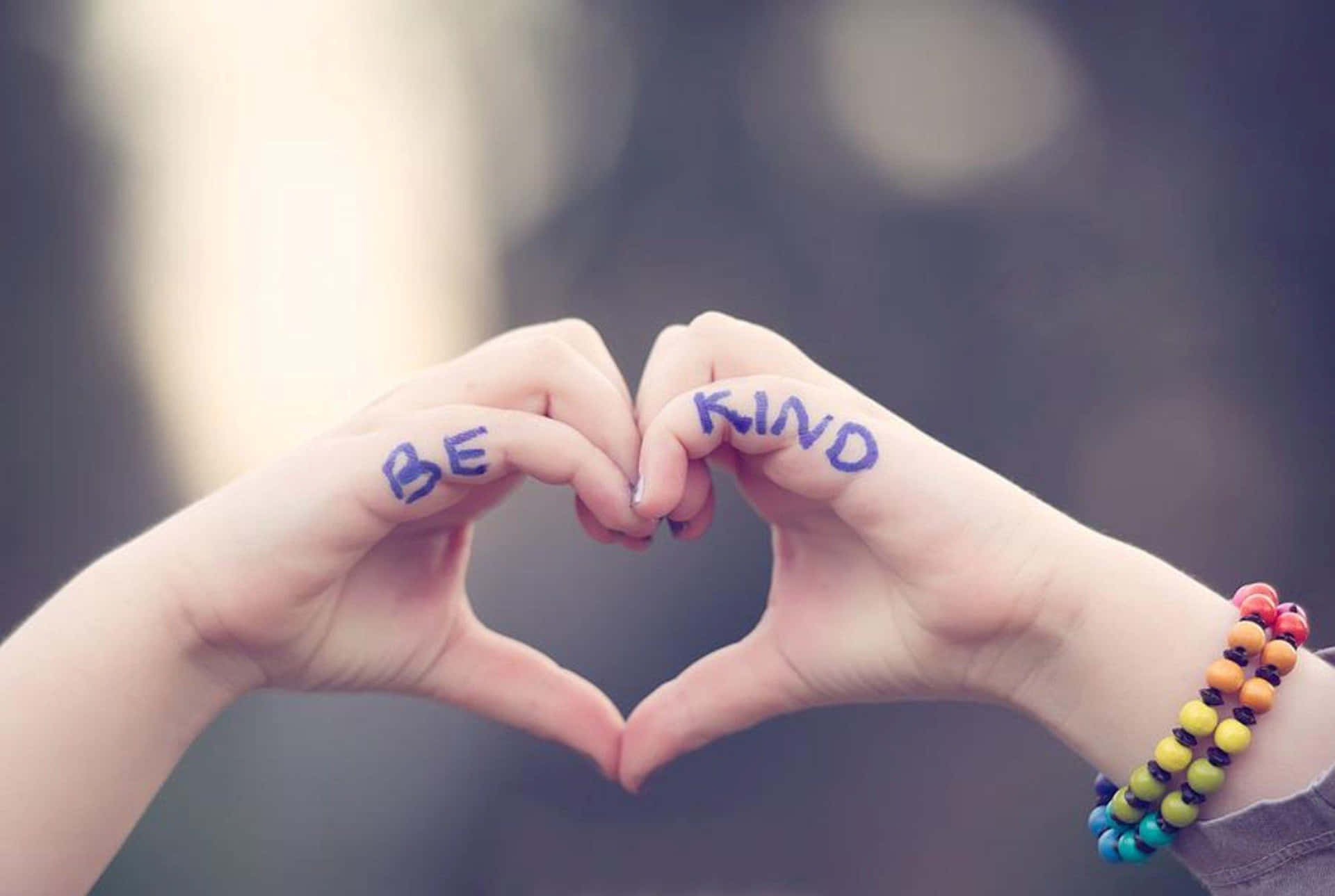 Warm Hands Embossed With 'be Kind' Message Background