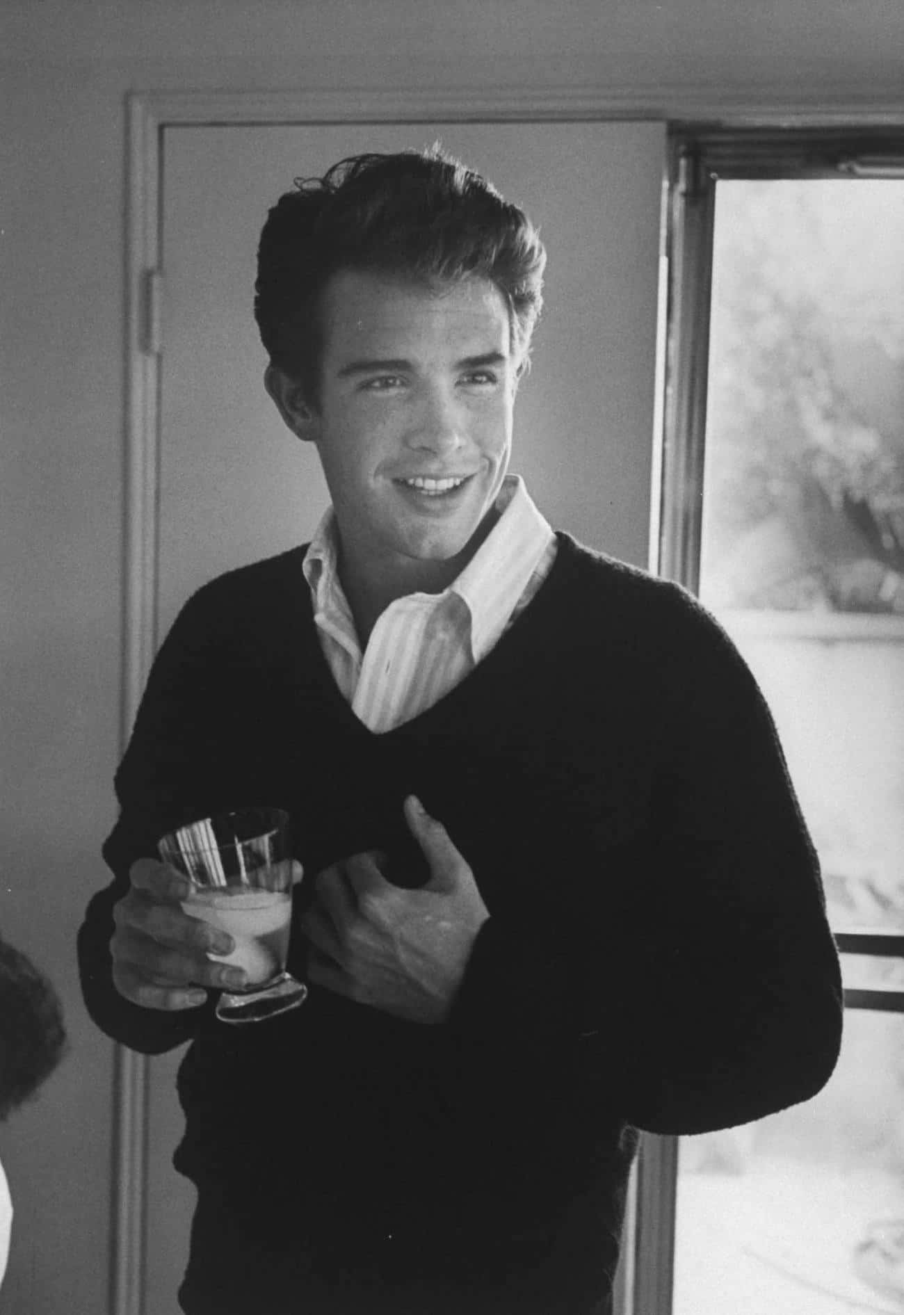 Warren Beatty Posing Confidently In A Suit Background