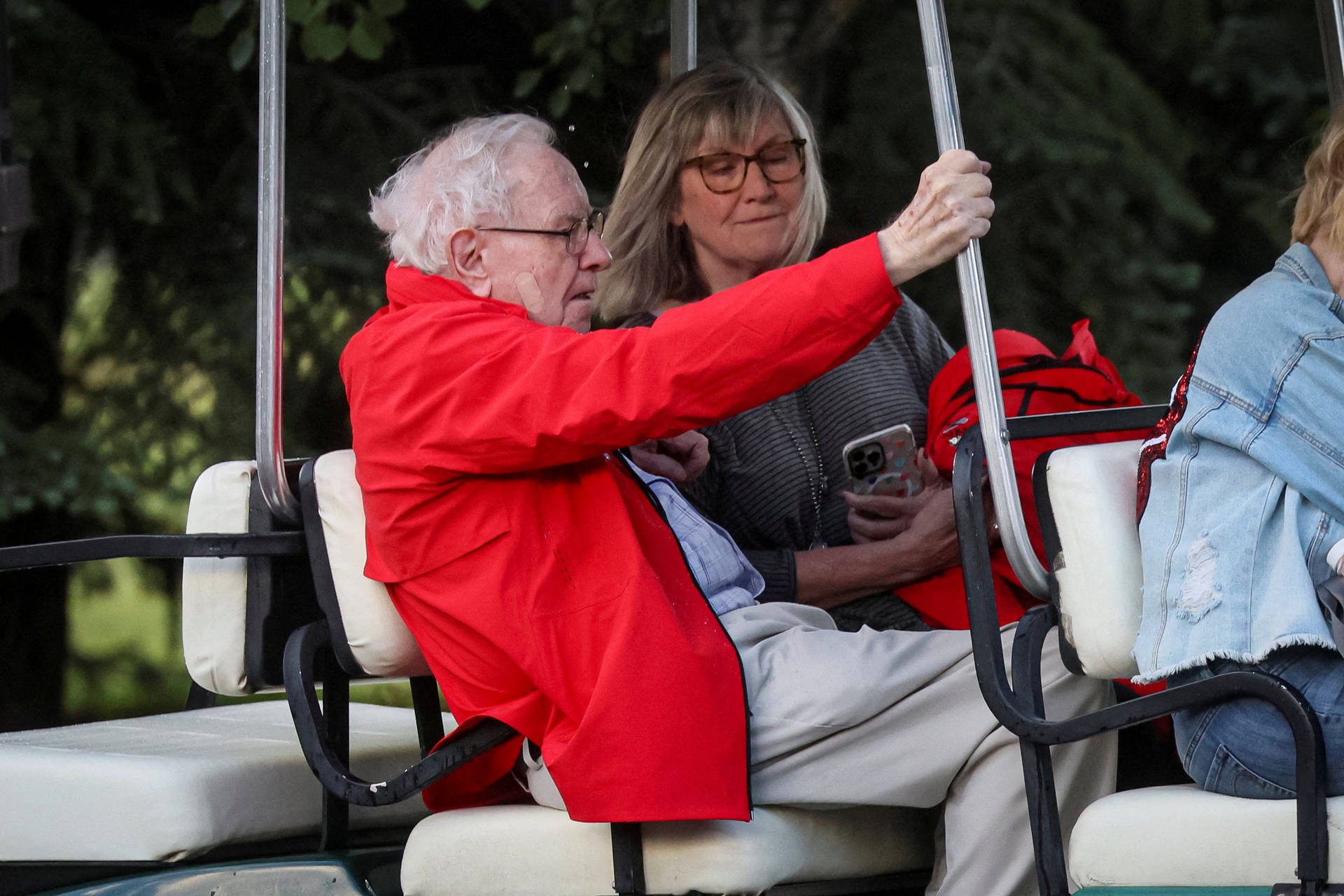 Warren Buffett Enjoying A Golf Cart Ride Background