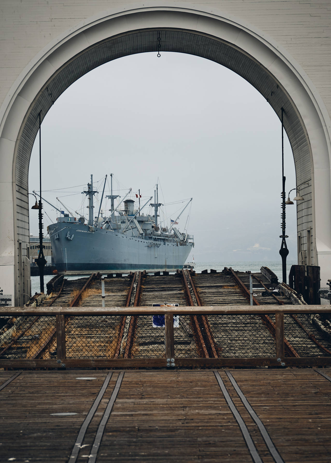 Warship Through An Arch Background