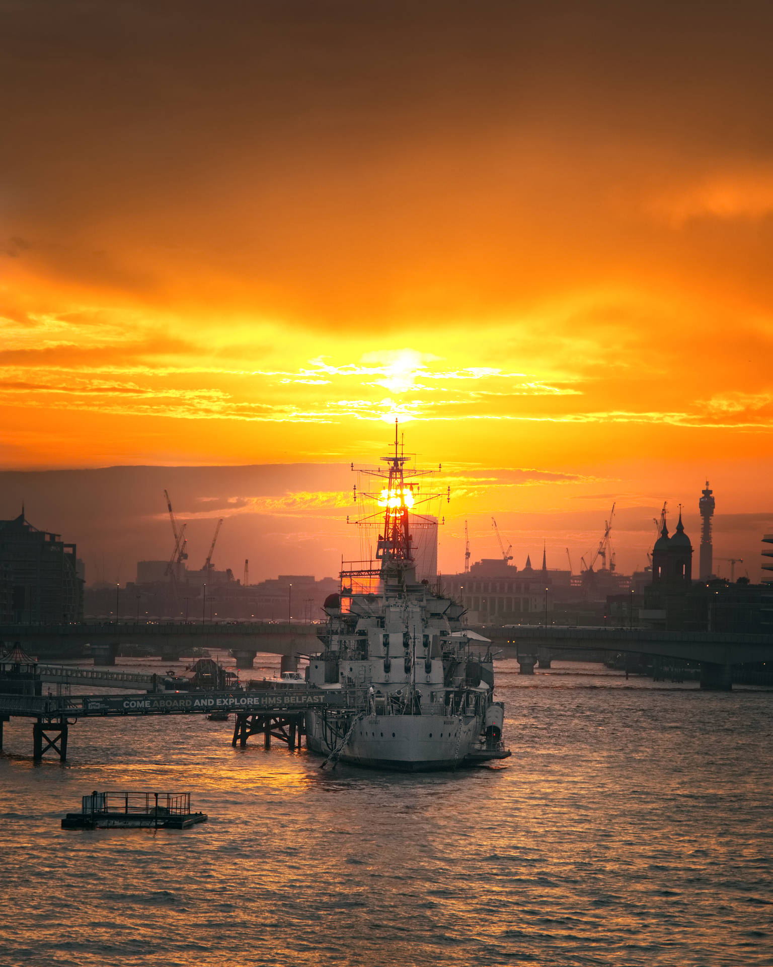 Warship Under An Orange Sunset Background