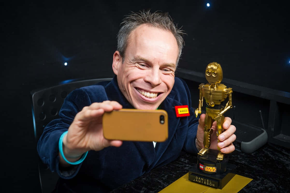 Warwick Davis Posing For A Portrait Background