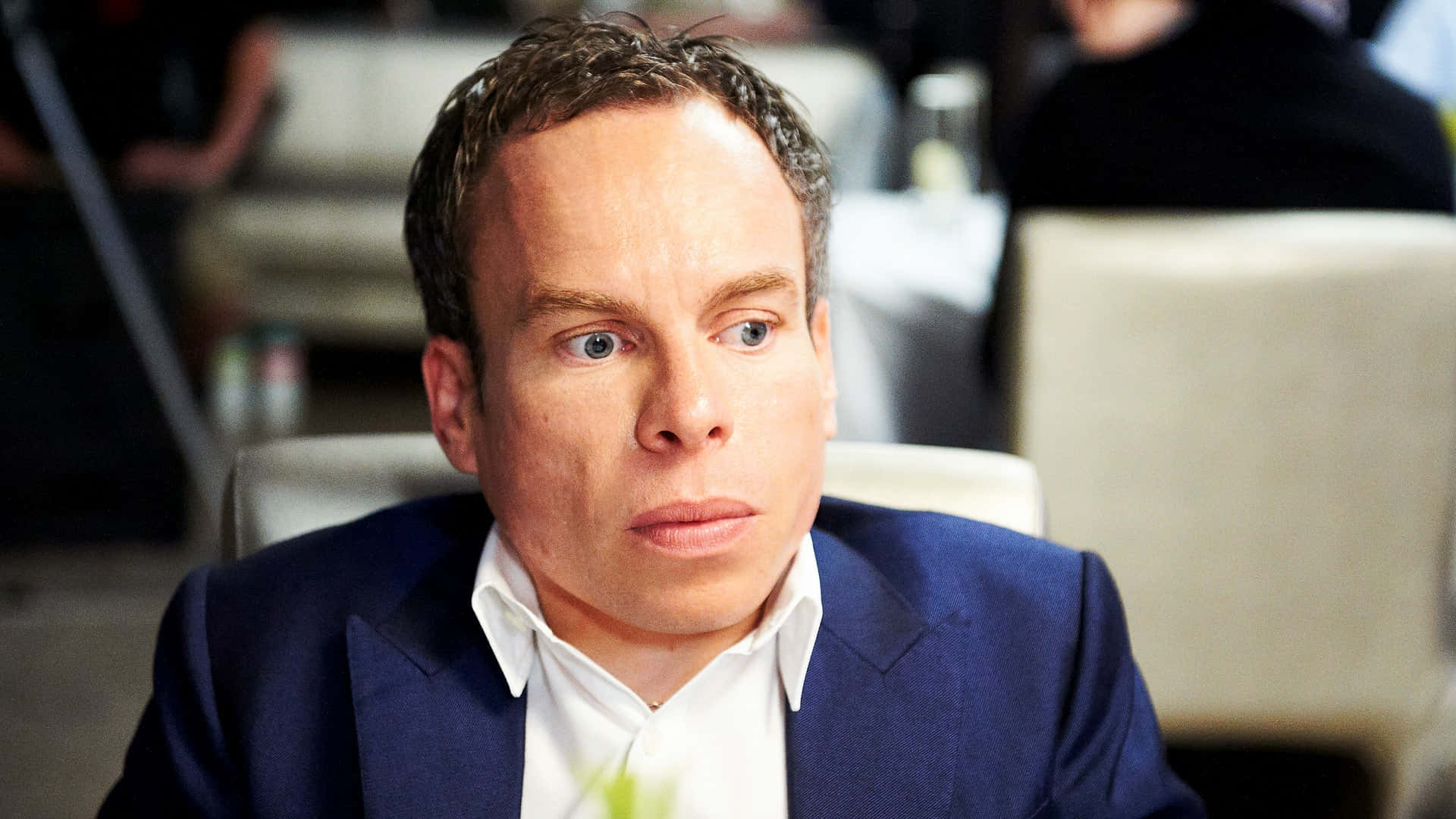 Warwick Davis Posing In A Studio Setting Background