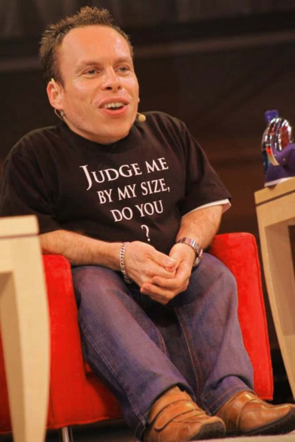 Warwick Davis Smiling And Wearing A Suit Background