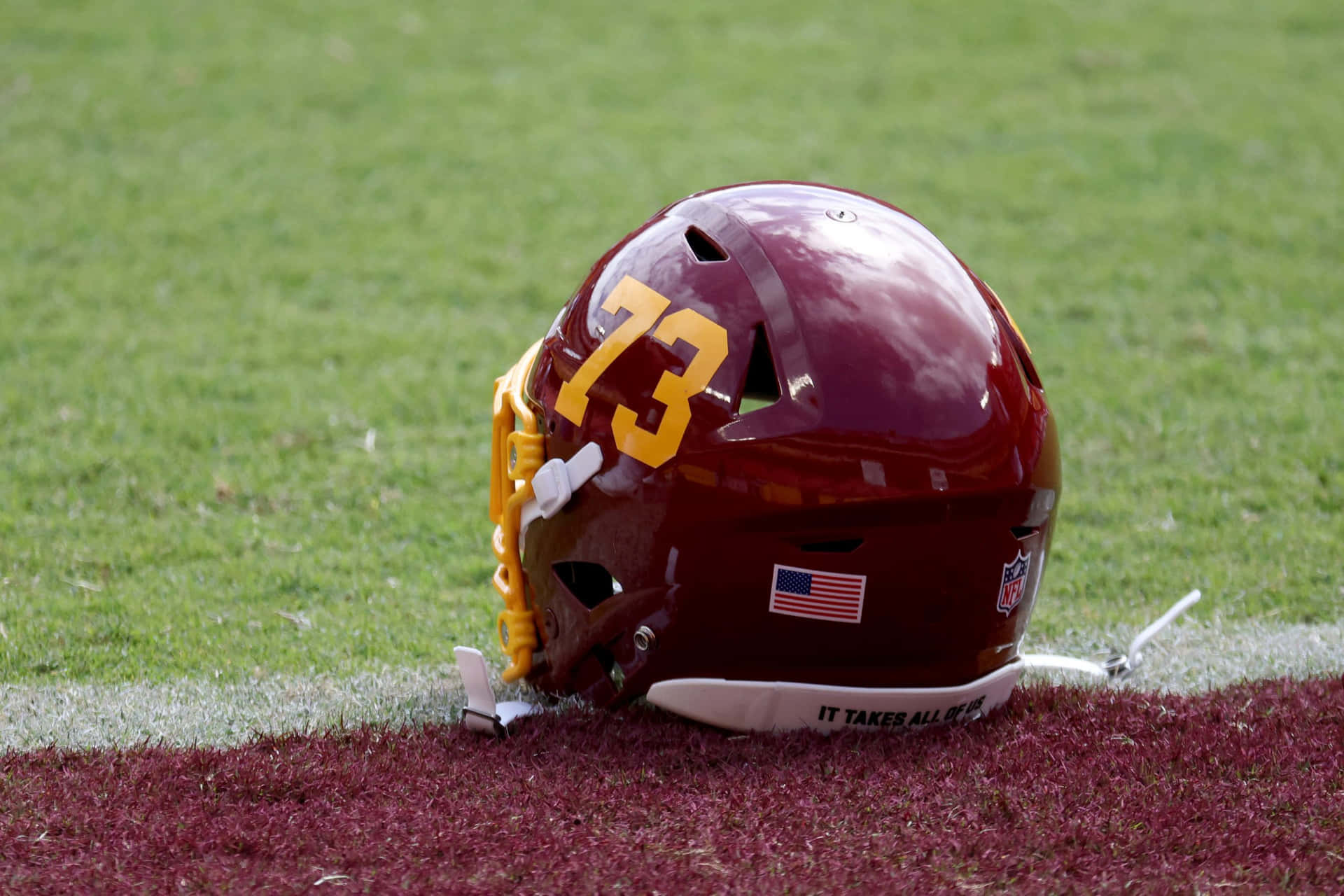 Washington Football Team Players In Action During A Game Background