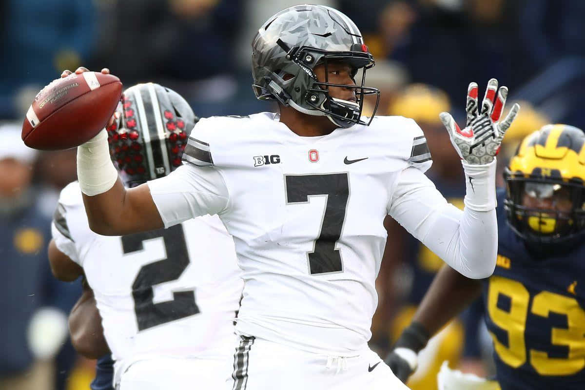 Washington Football Team Quarterback Dwayne Haskins Taking The Field Background