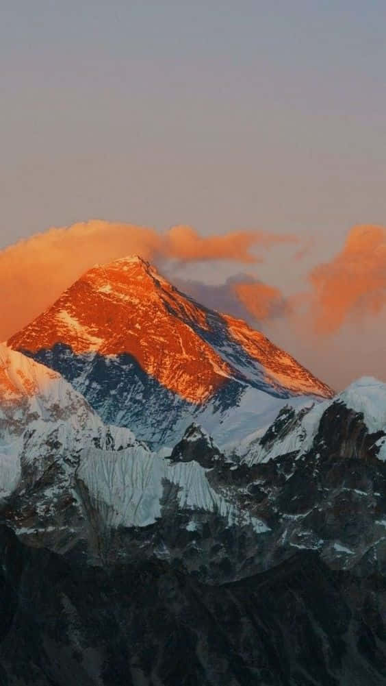 Watch The Sun Dip Below The Snow-capped Mountain Tops At Sunset. Background