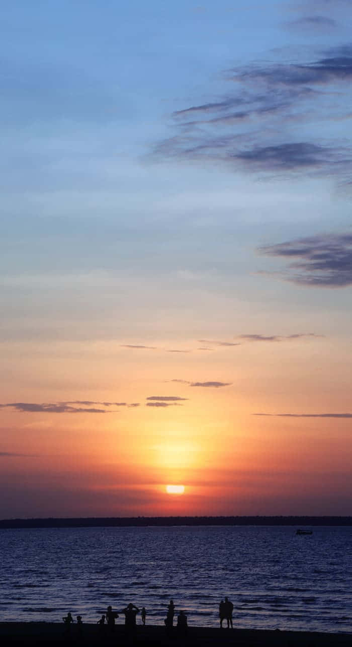 Watch The Sunset Over Picturesque Beachscape Background