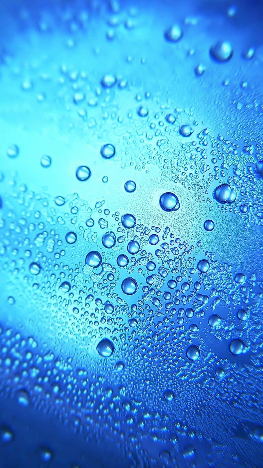 Water Droplets On A Blue Glass Background