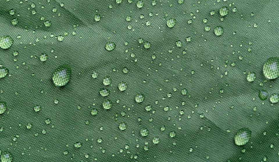 Water Droplets On Green Fabric