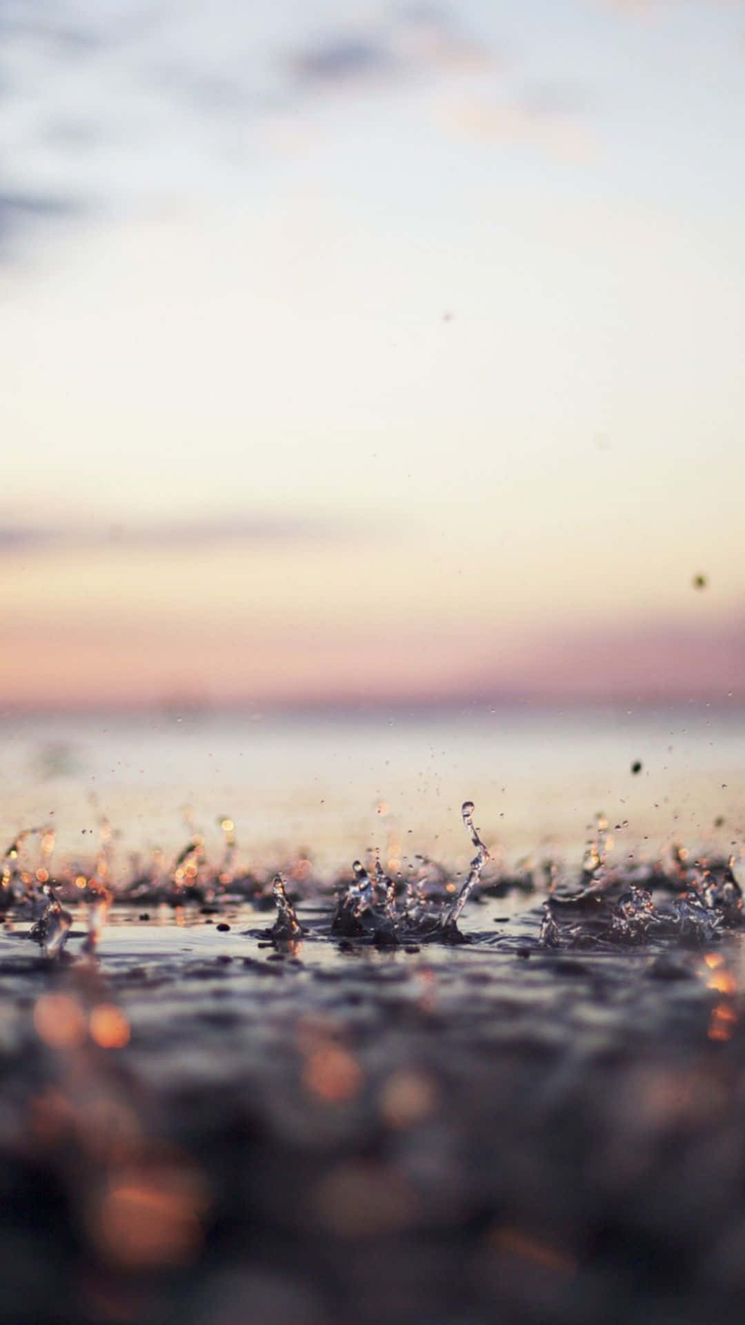 Water Splashes On The Beach At Sunset Background
