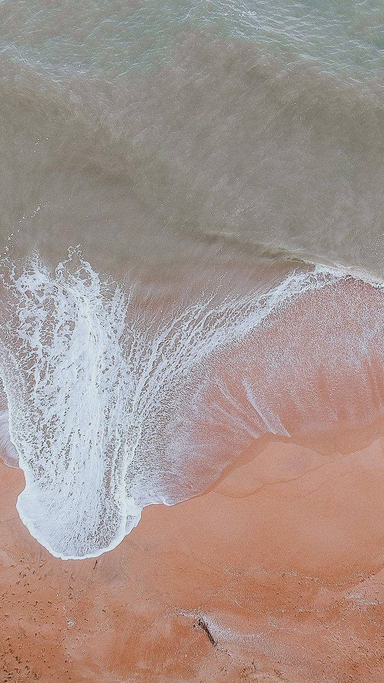 Wave Over Orange Sand Ios 12 Background