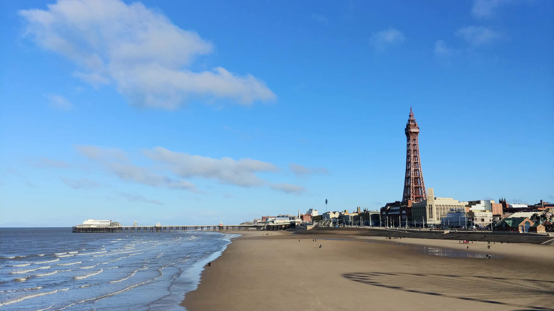 Waves Hitting Beach With Blackpool Tower In Background Background
