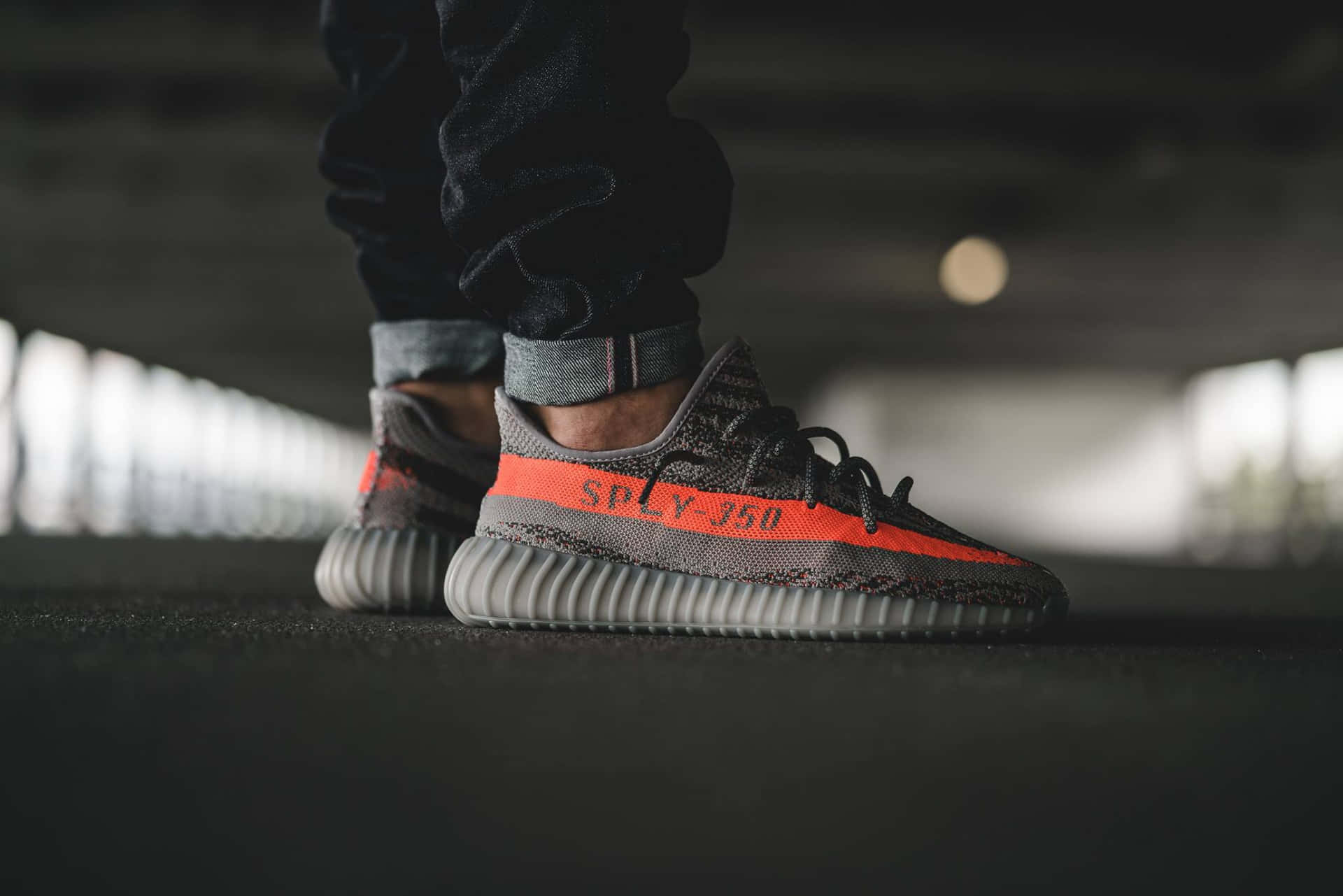 Wearing A Yeezy Boost 350in Orange Background