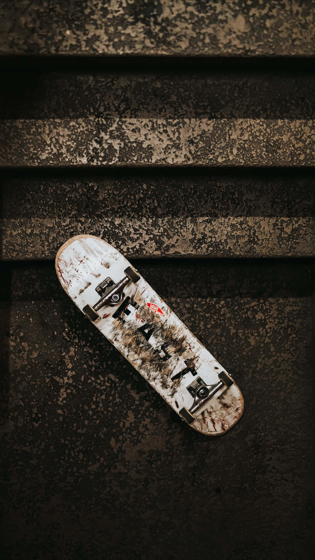 Weathered Skateboardon Stairs Background