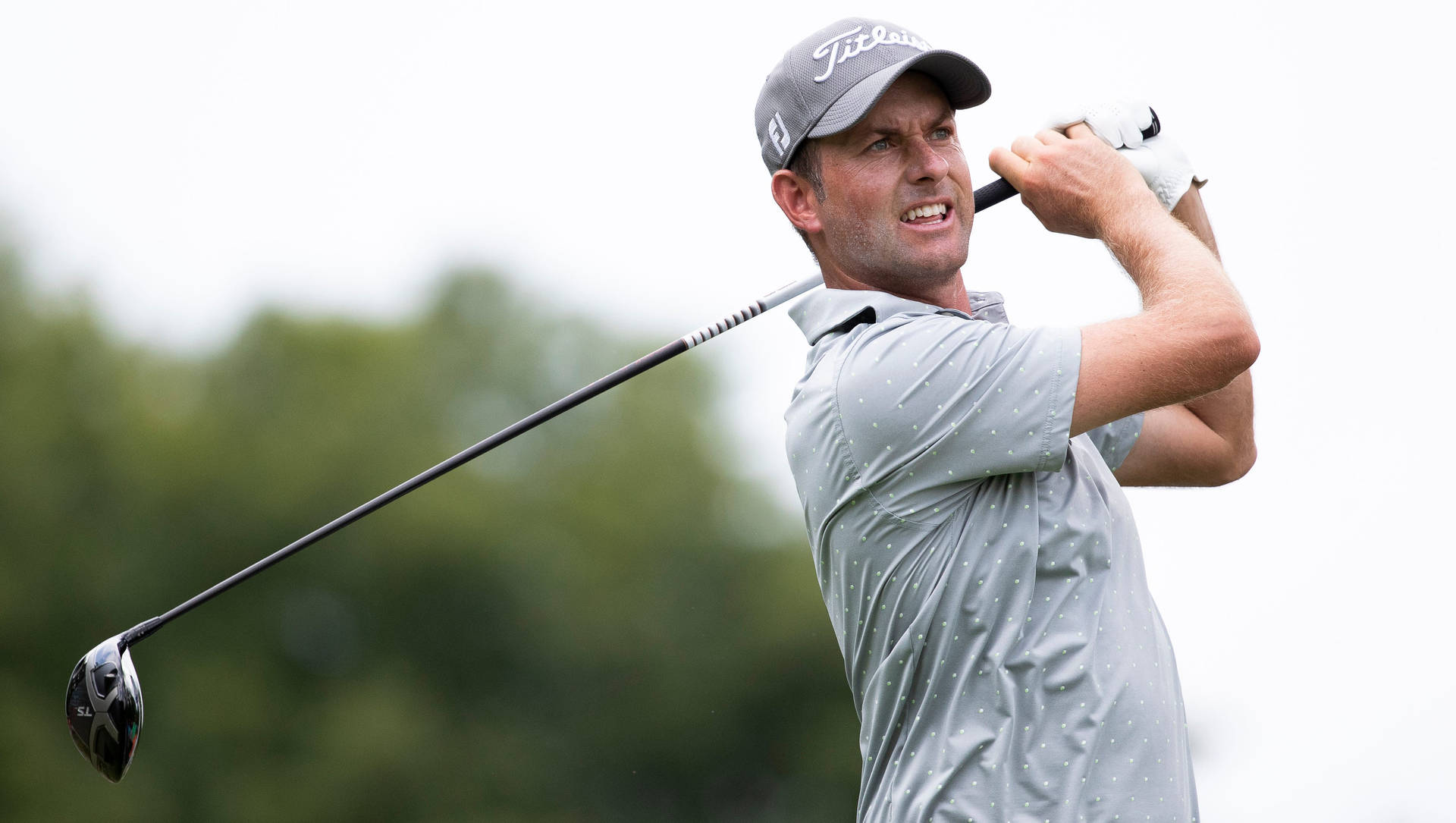 Webb Simpson Smiling After A Swing Background