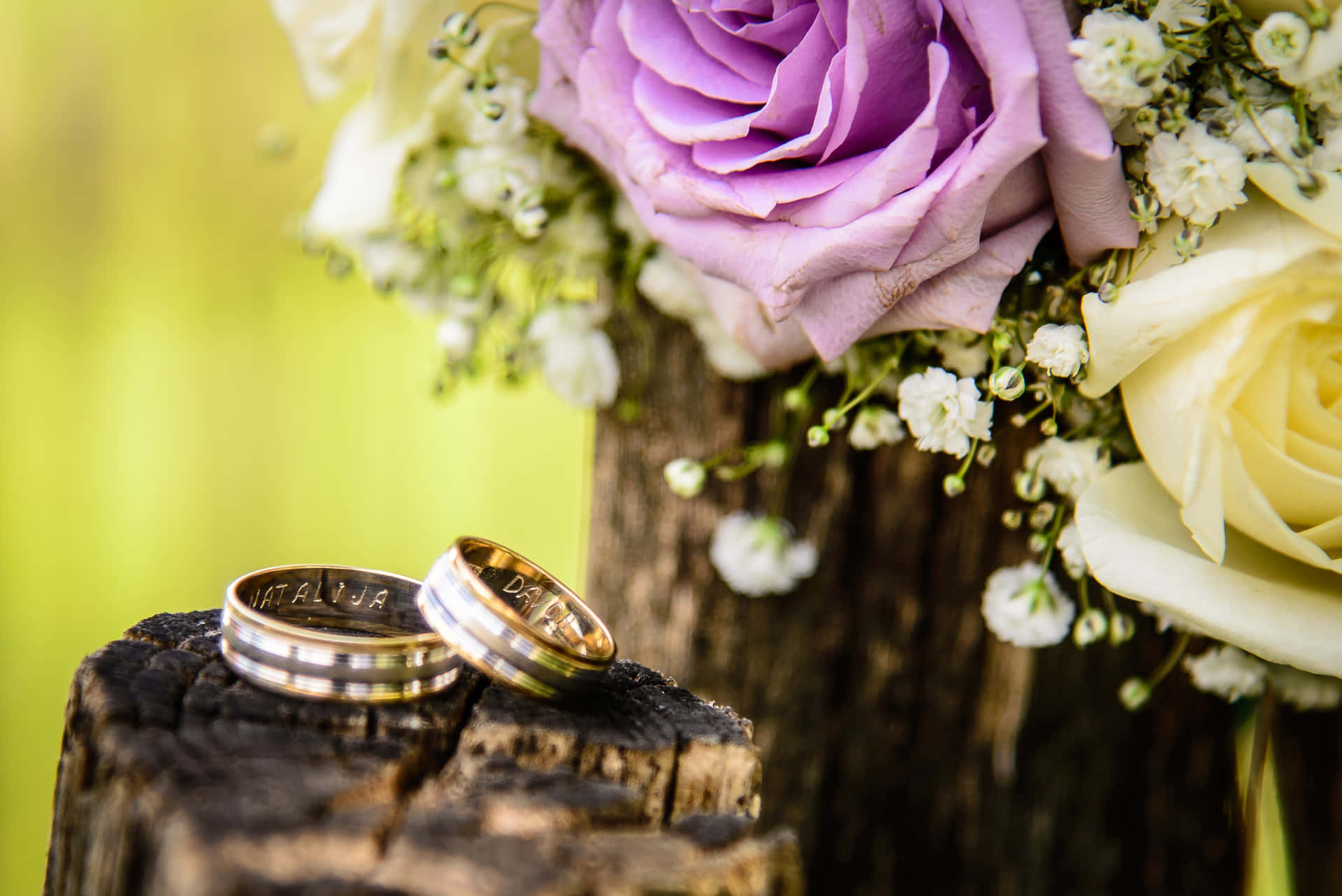 Wedding Ring On Wood With Flowers Background