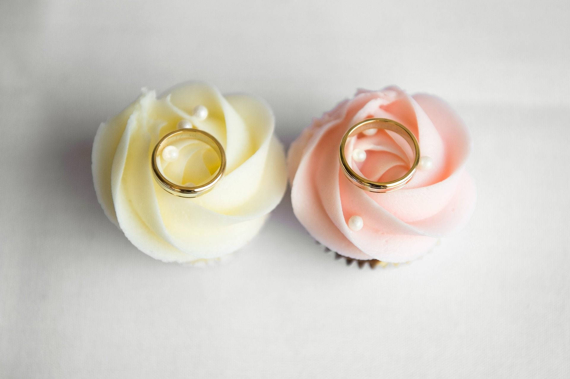 Wedding Rings On Pastel Flowers Background