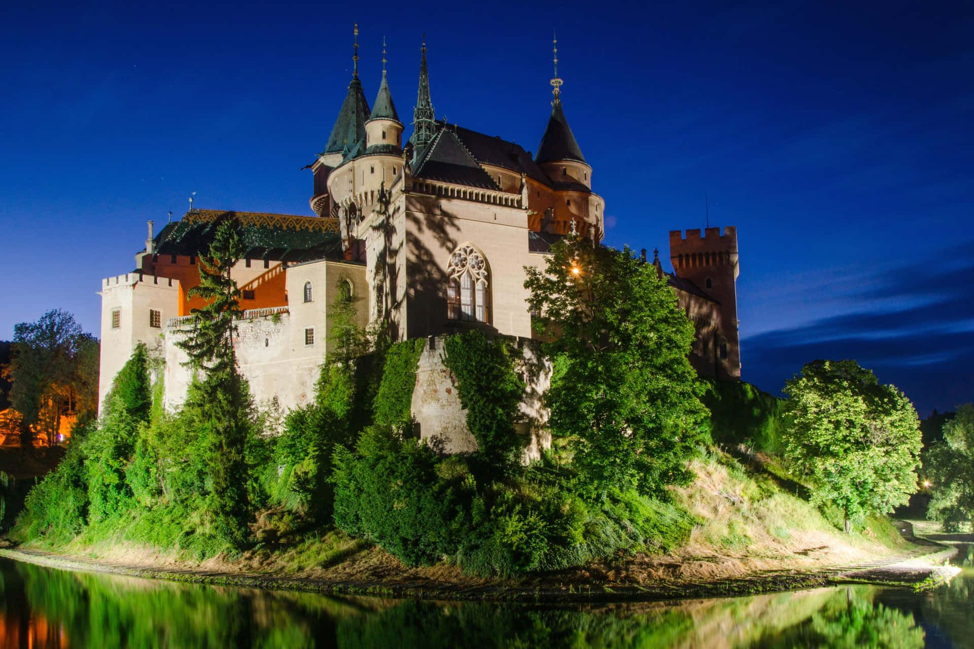 Well-lit Bojnice Castle Beneath Evening Sky Background