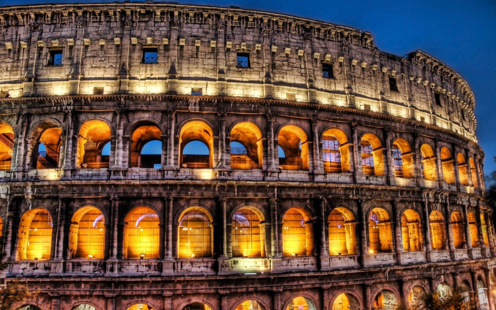 Well-lit Colosseum At Night Desktop Background