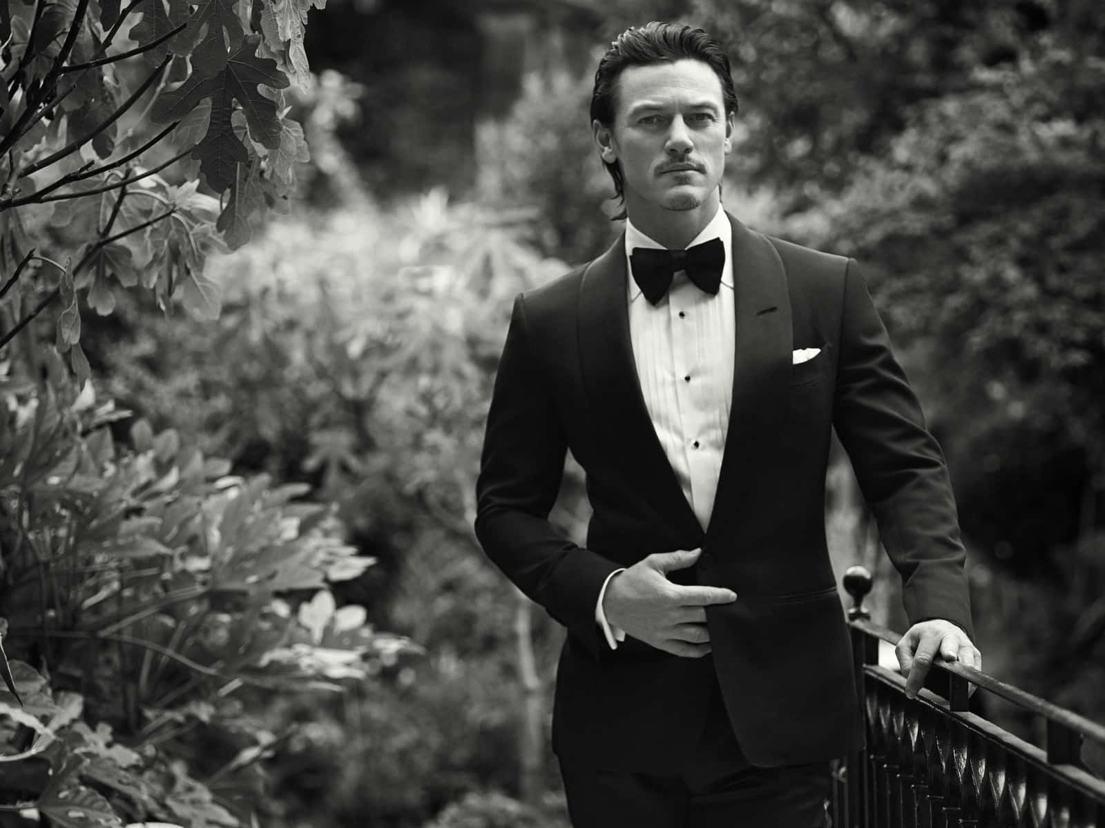 Welsh Actor Luke Evans In A Classic Men Suit Style Background