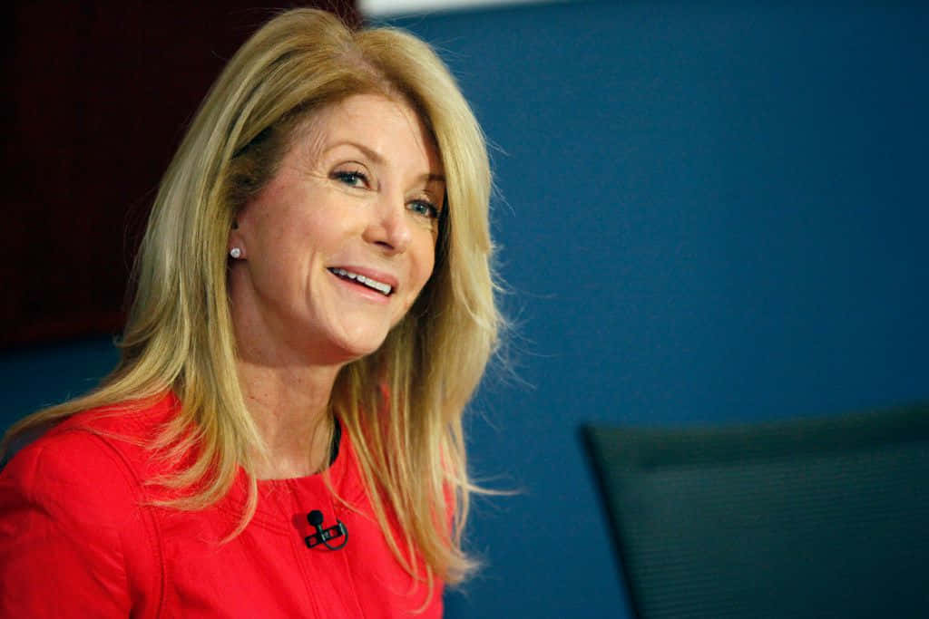 Wendy Davis Donning A Red Dress Background