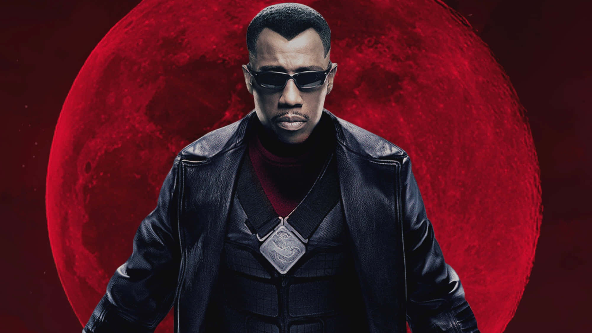 Wesley Snipes Confidently Posing In A Black Outfit And Sunglasses Background