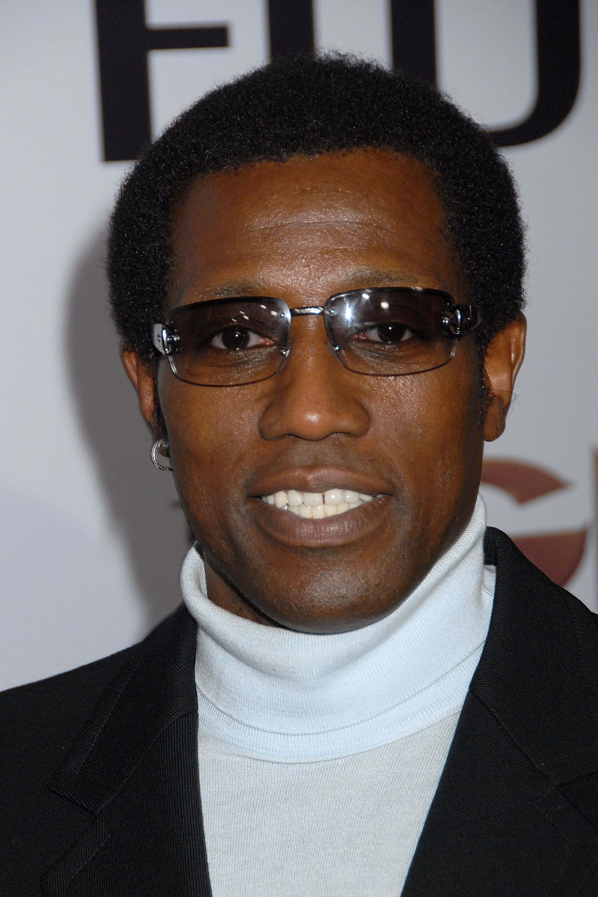 Wesley Snipes Exuding Confidence In A Sleek Black Suit Background