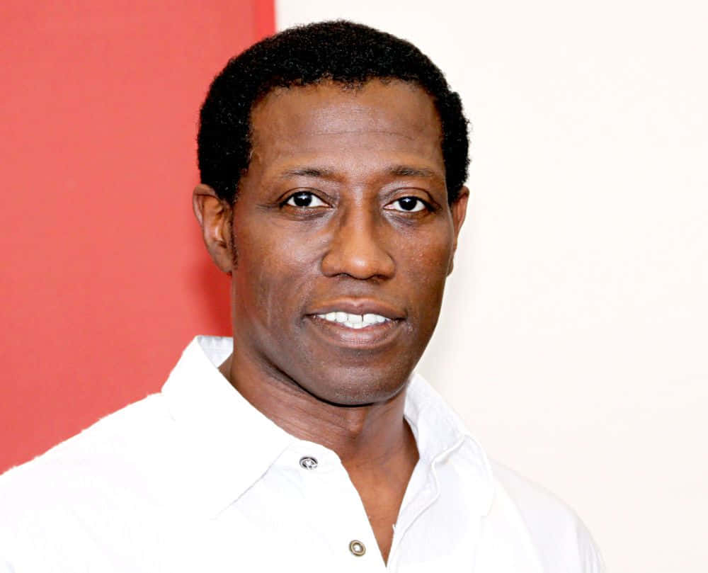Wesley Snipes Striking A Confident Pose Background