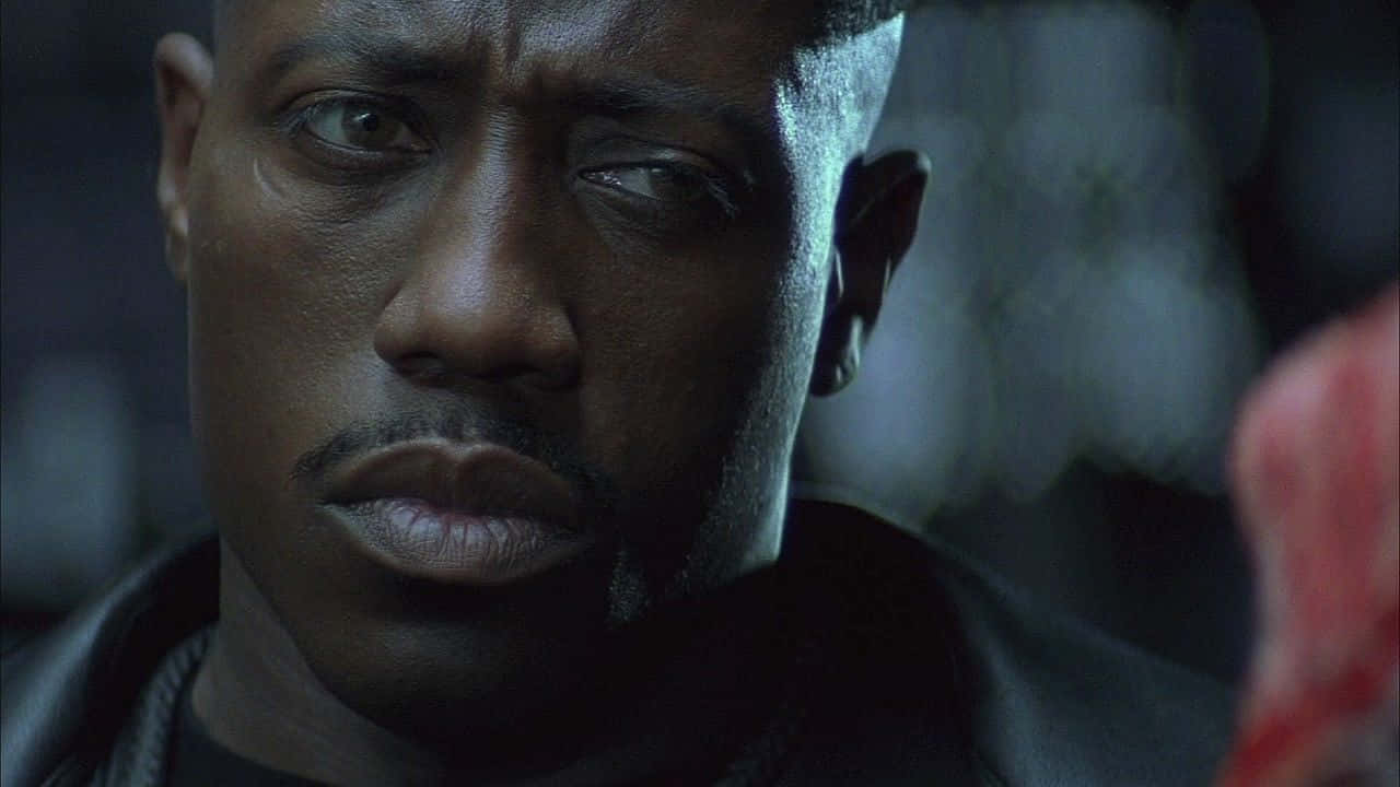 Wesley Snipes Striking A Pose In A Stylish Outfit Background