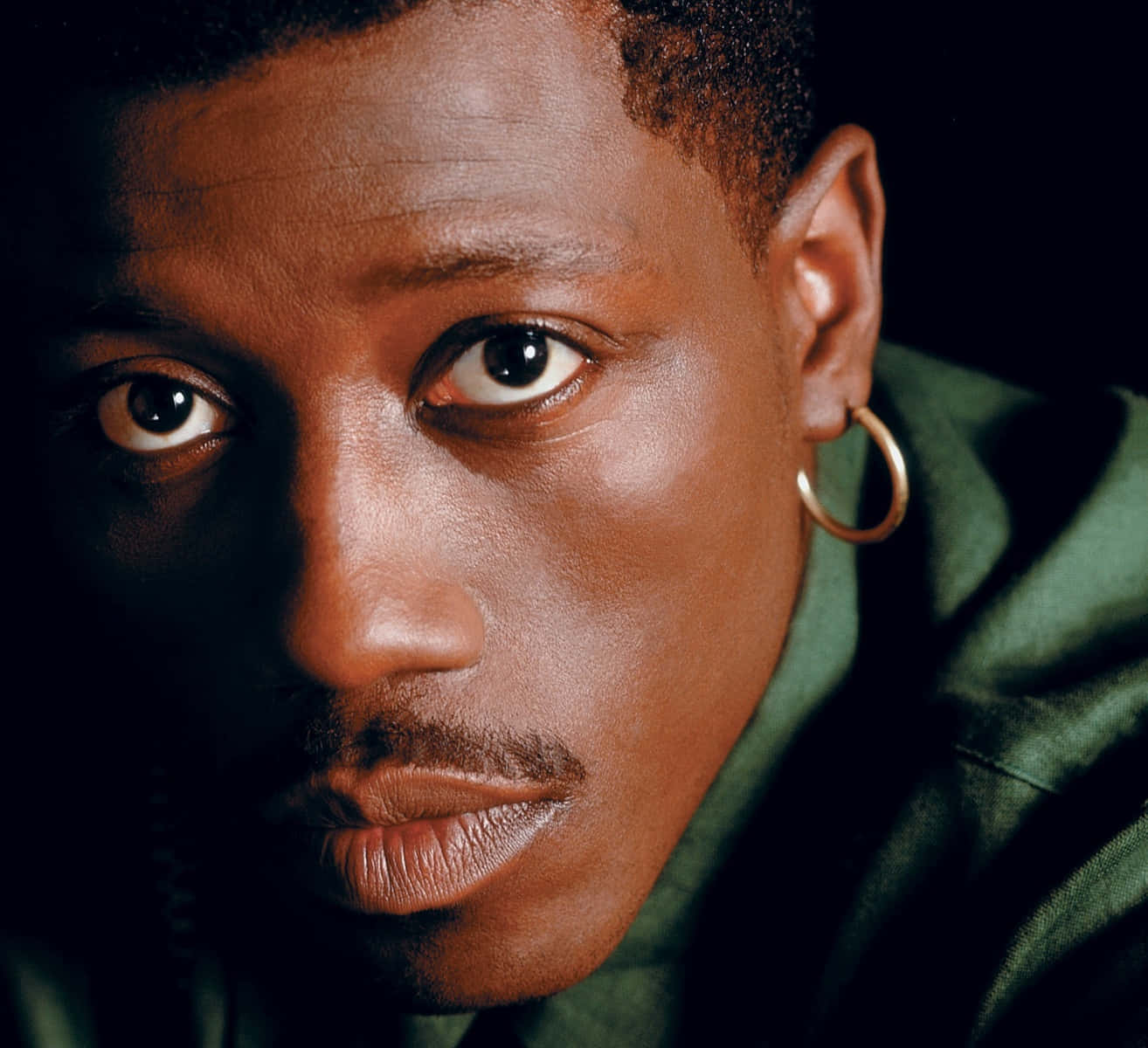 Wesley Snipes Striking A Pose In An Elegant Outfit Background