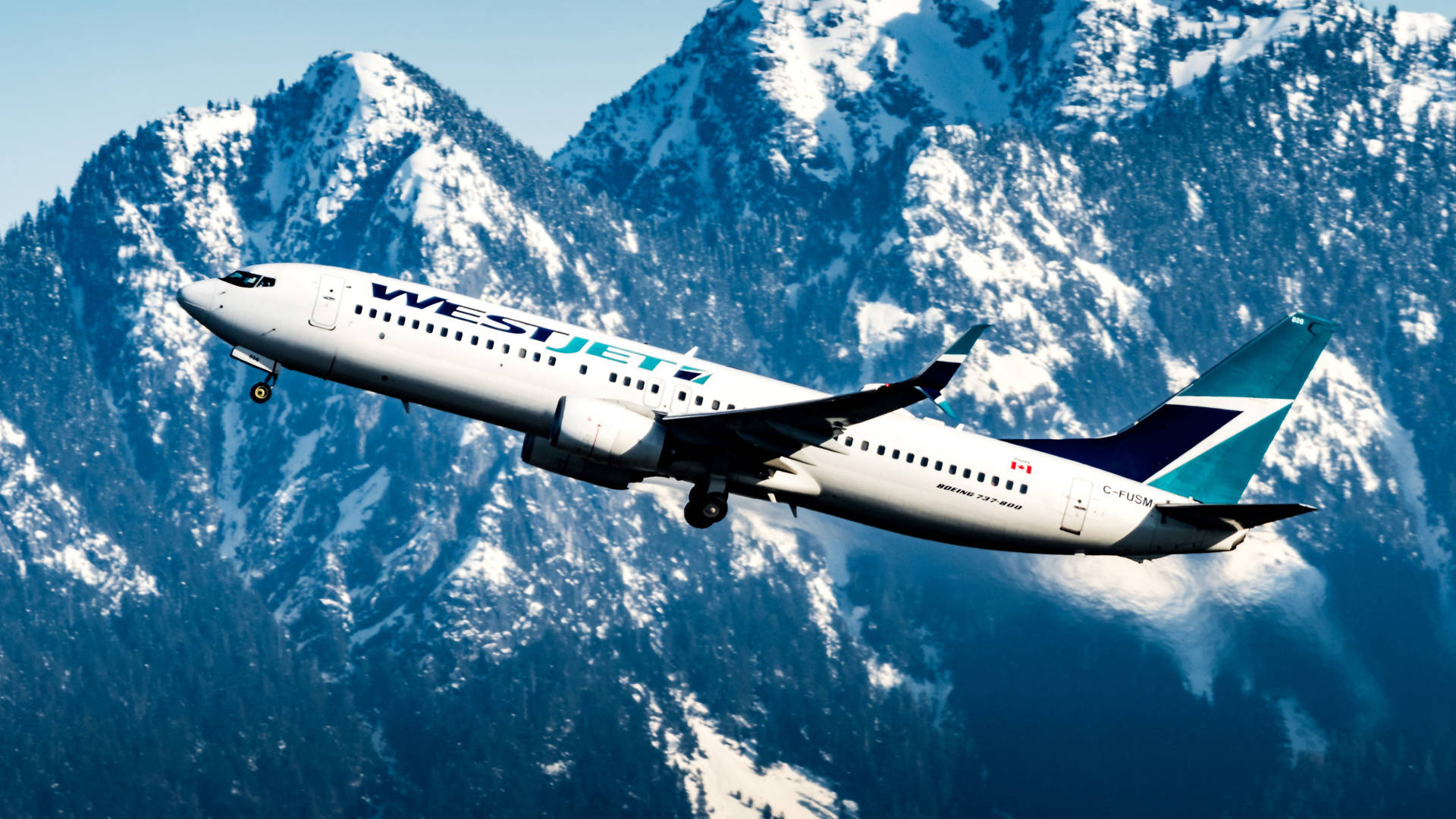 Westjet Airline Plane Over Mountains