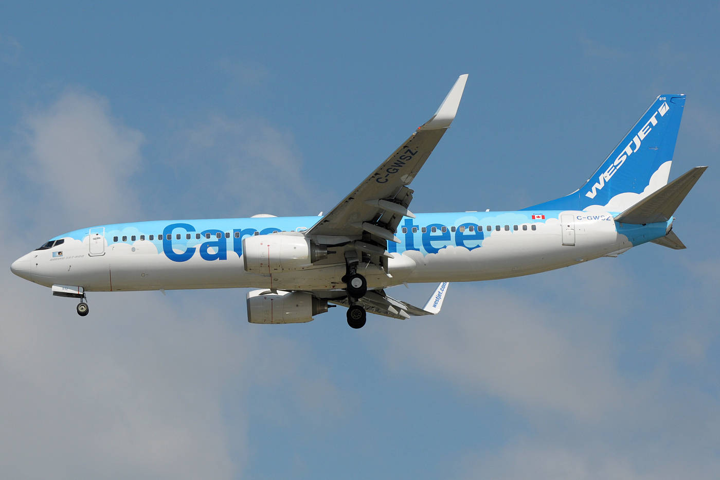 Westjet Airlines In Flight Against A Vivid Sky Background