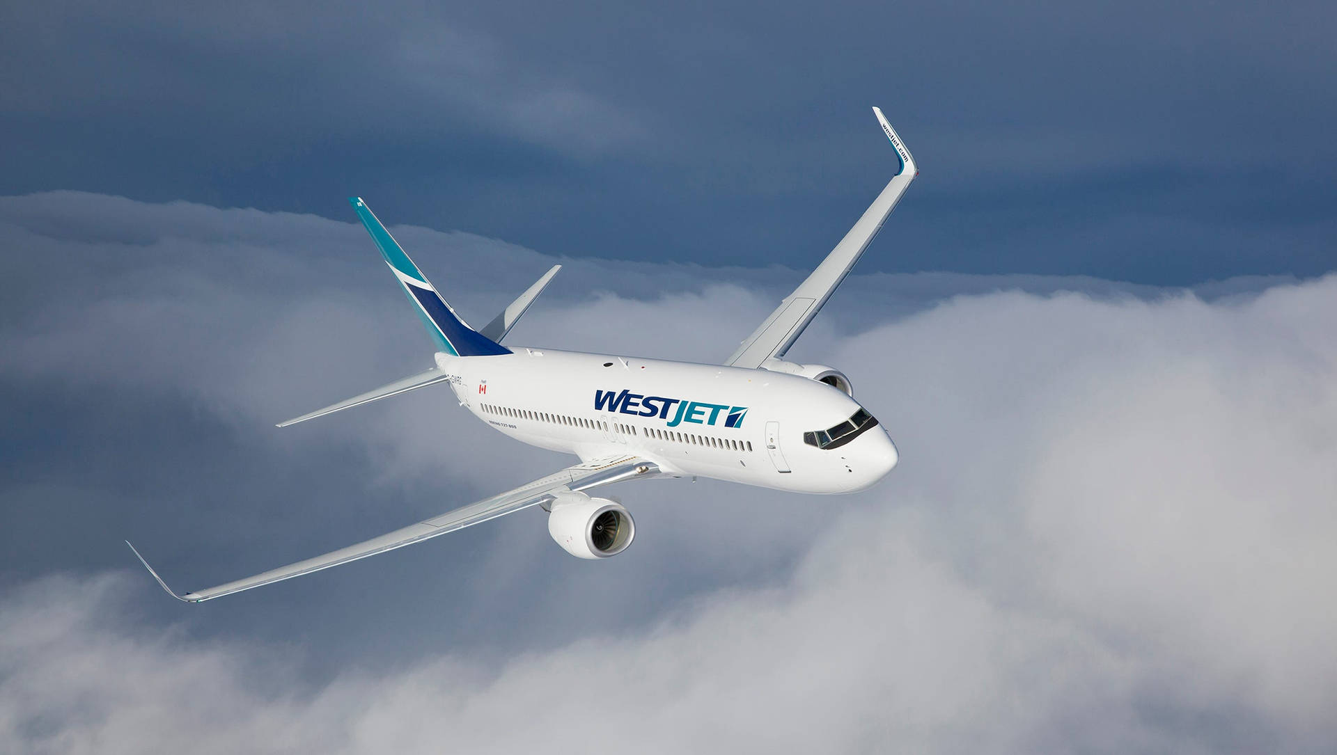 Westjet Airplane Gliding Over Cloudy Sky Background