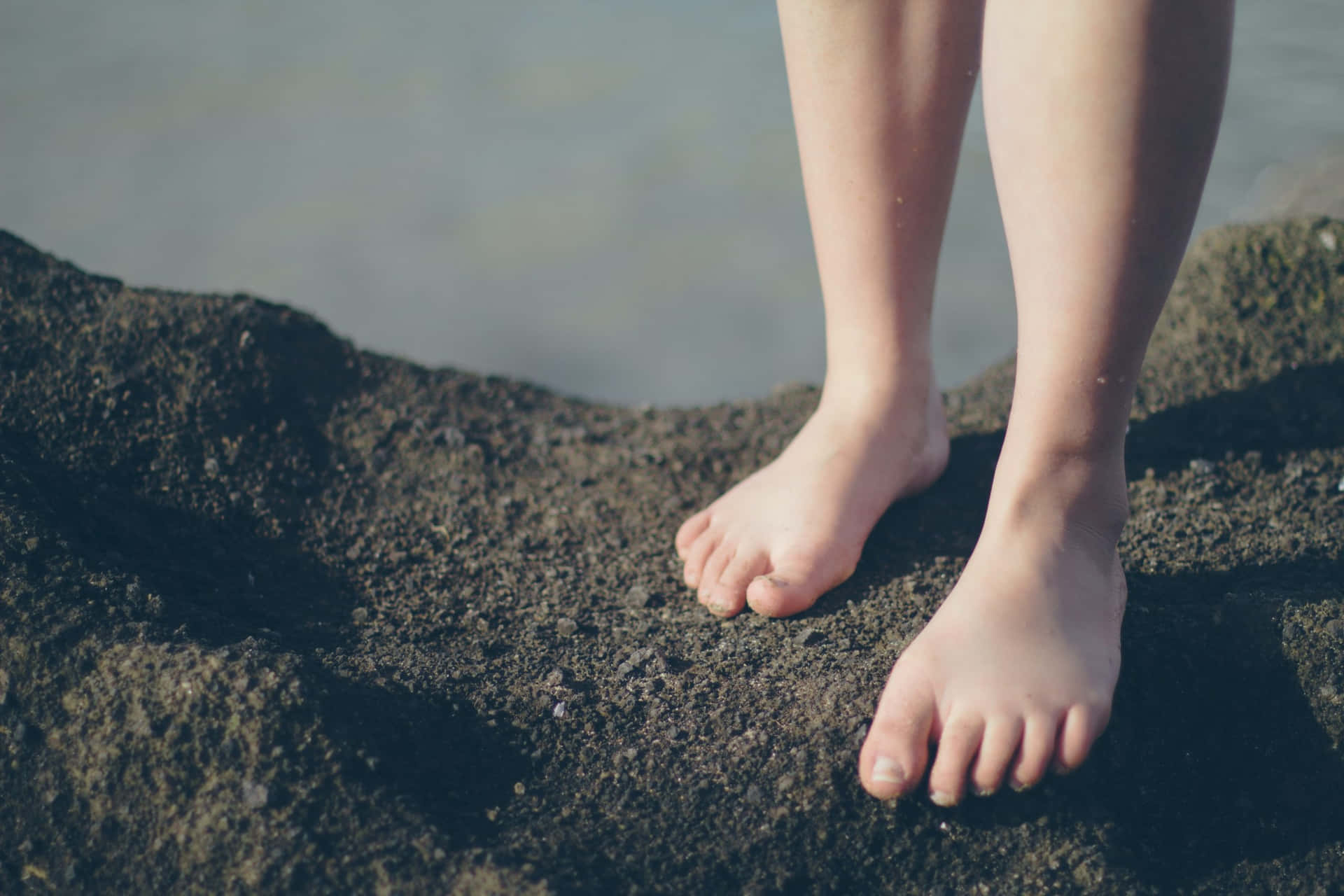 Wet Girl Feet On Sand Background