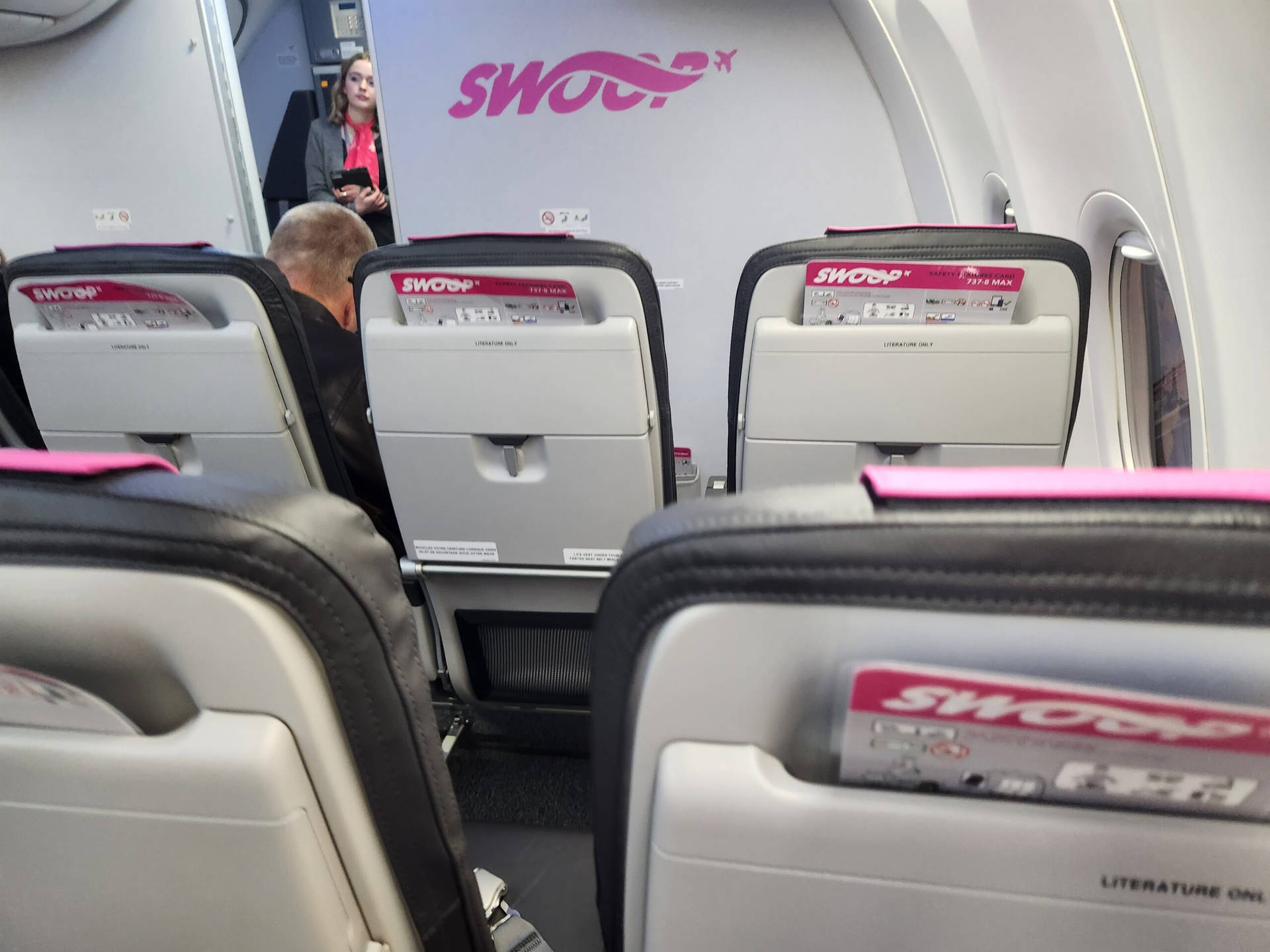 White And Pink Seats Of Swoop Aircraft Background