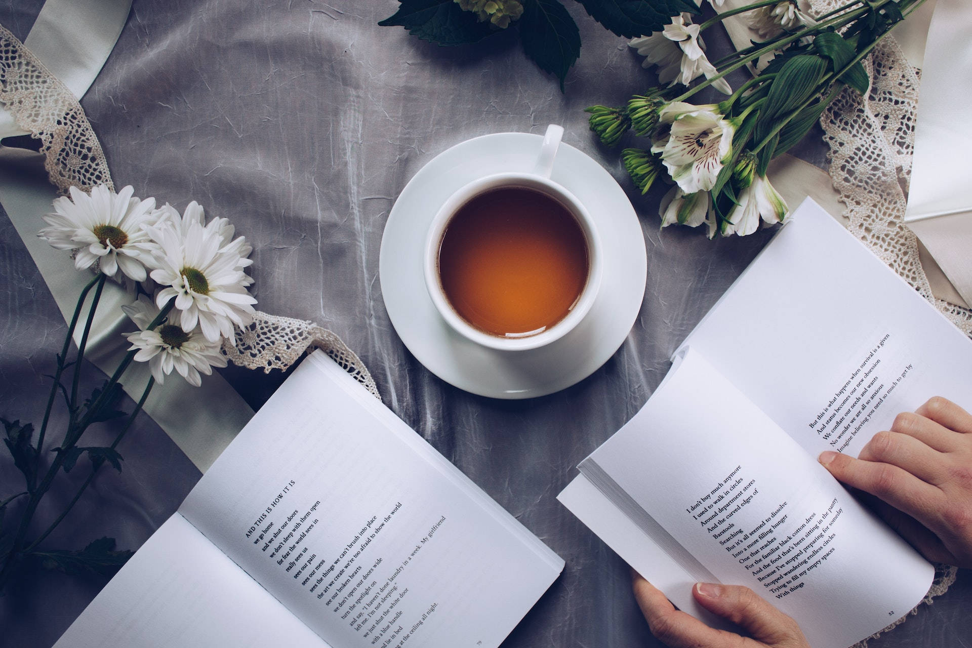 White Ceramic Teacup With Saucer Near Two Books