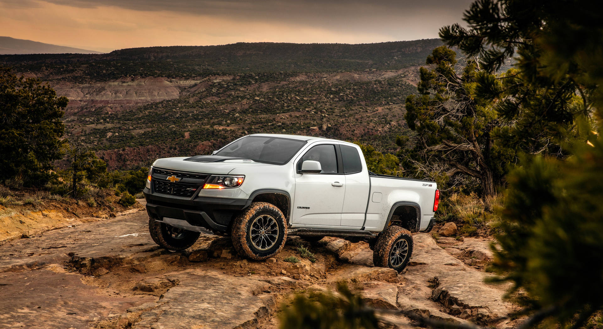 White Duramax Climbing Up A Mountain Background